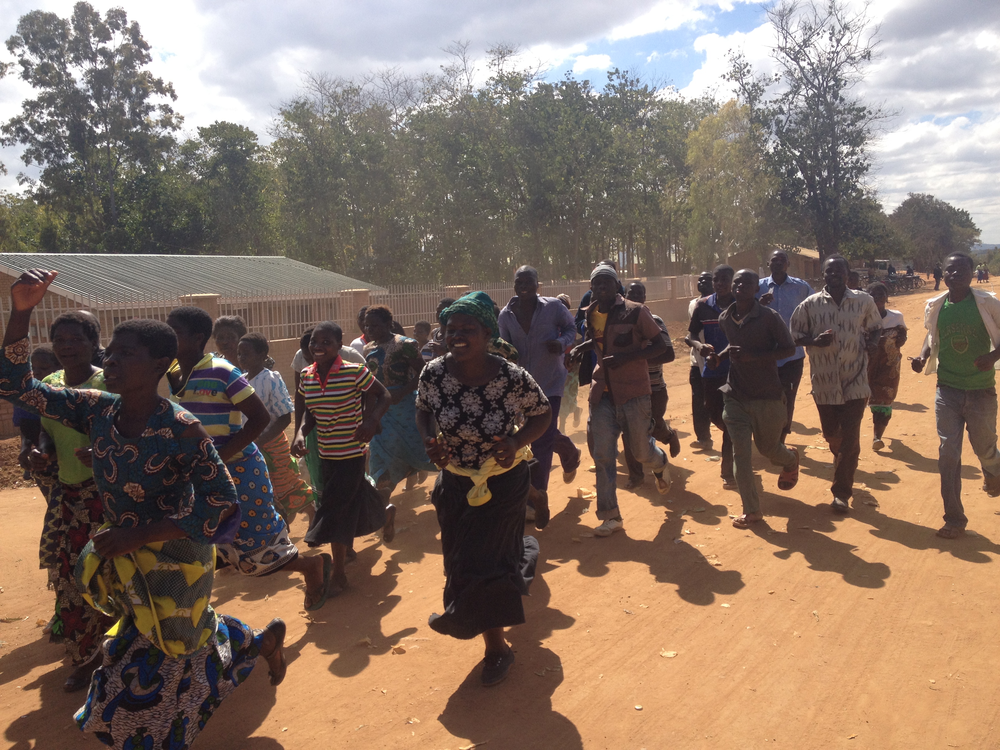 Supporters of Peter Mutharika, the main challenger to President Joyce Banda in the upcoming 2014 presidential elections, sing en route to a political rally. Mutharika has criticized President Banda for her approach to a currency devaluation in May 2012. Image by Luke Messac. Malawi, 2013. Media file: malawi_rally.jpg