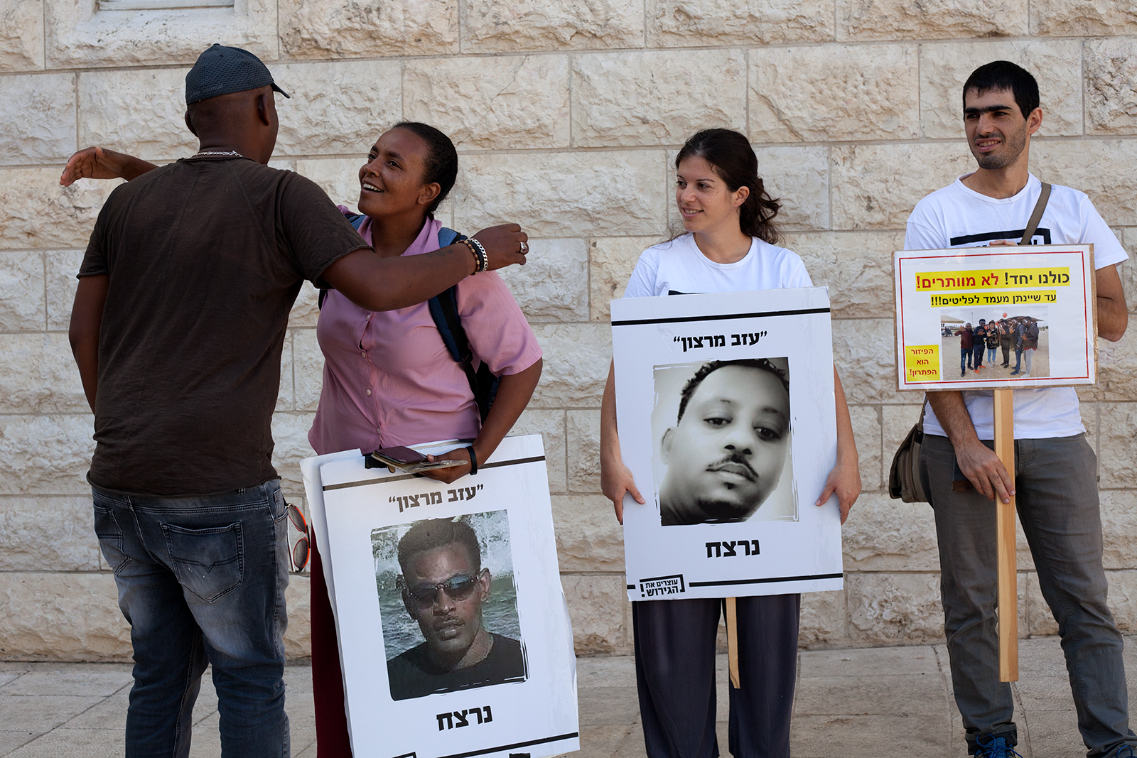 On July 24, 2018, a group of demonstrators, including Bisrat Geryasus (second from left), protest Israel's "Deposit Law" outside the country's Supreme Court. Image by Caron Creighton. Israel, 2018. From Caron Creighton's Pulitzer Center student fellow project, "Eritrean and Sudanese Asylum Seekers in Israel." On July 24, 2018, a group of demonstrators, including Bisrat Geryasus (second from left), protest Israel's "Deposit Law" outside the country's Supreme Court. Image by Caron Creighton. Israel, 2018. From Caron Creighton's Pulitzer Center student fellow project, "Eritrean and Sudanese Asylum Seekers in Israel."