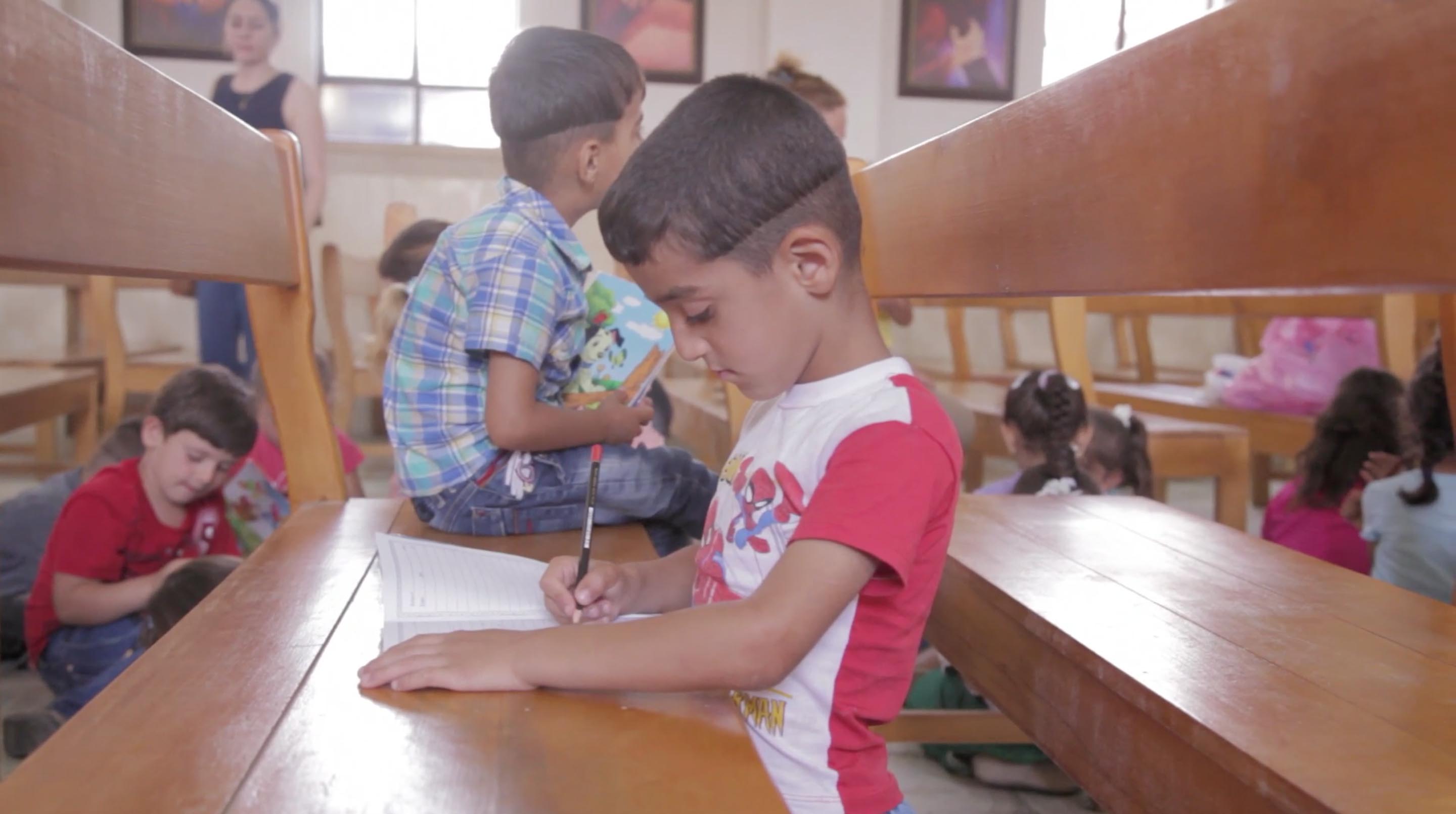 A young boy attends class inside the Mari Lia Church in Erbil. Image by Sebastian Meyer. Iraq, 2014. Media file: screen_shot_2014-09-18_at_12.16.03_am.jpg