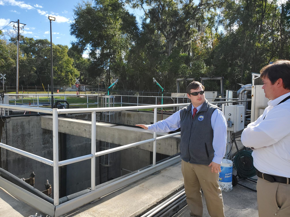 Brunswick-Glynn County Joint Water-Sewer Commission Executive Director Andrew Burroughs and Director of Engineering Todd Klein stand by the wet well at the Academy Creek Wastewater Treatment Plant. Its low walls mean water from a flood could infiltrate it. Image by Emily Jones/GPB News. United States, 2020. Brunswick-Glynn County Joint Water-Sewer Commission Executive Director Andrew Burroughs and Director of Engineering Todd Klein stand by the wet well at the Academy Creek Wastewater Treatment Plant. Its low walls mean water from a flood could infiltrate it. Image by Emily Jones/GPB News. United States, 2020.