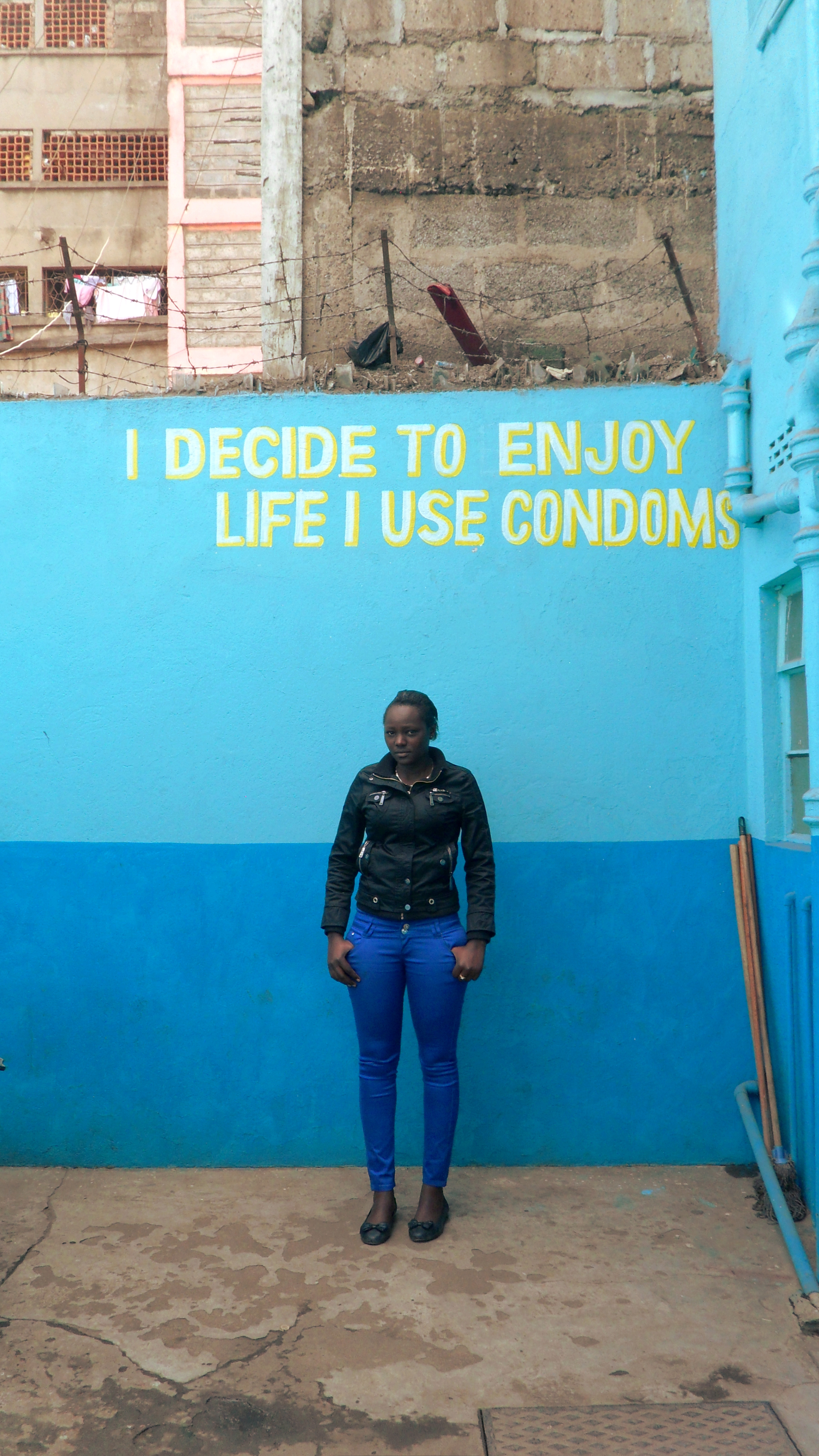 Josephine Kimani, 24, stands inside the Family Health Options Kenya Youth Center in Eastleigh. Image by Adiba Khan. Kenya, 2014. Media file: photo_main_article_khan.jpg