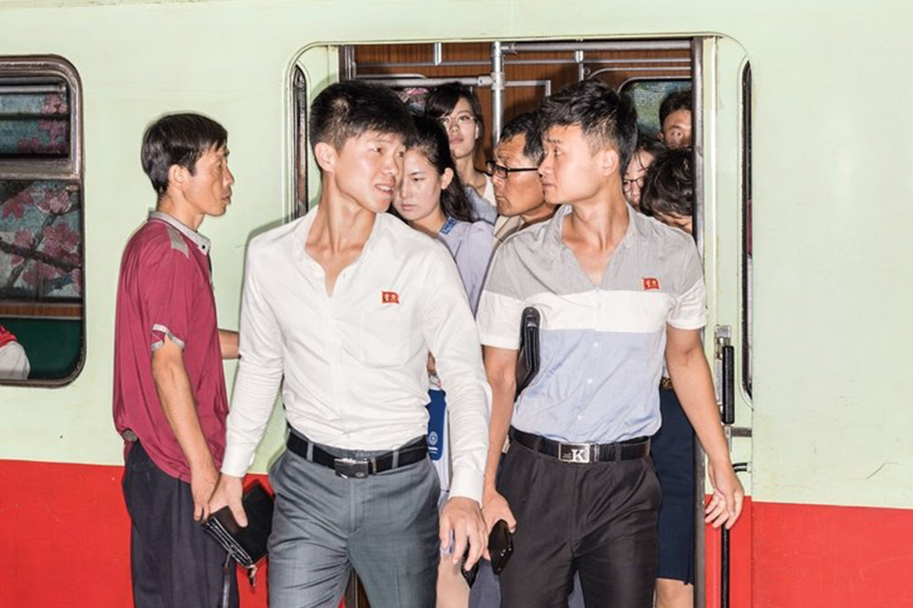 North Korean commuters. Commuters on the Pyongyang Metro. The capital, marooned by politics, presents a panorama from another time. Image by Max Pinckers/The New Yorker. North Korea, 2017.