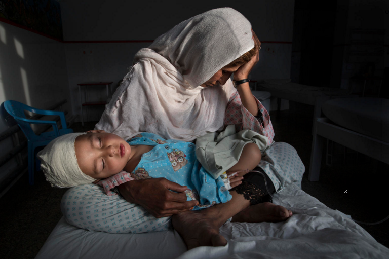 Najiba holds her nephew, Shabir, who was injured from the same bomb blast that killed his sister. Najiba watched over the children while Shabir’s mother buried her daughter. Image by Paula Bronstein. Afghanistan, 2016. Najiba holds her nephew, Shabir, who was injured from the same bomb blast that killed his sister. Najiba watched over the children while Shabir’s mother buried her daughter. Image by Paula Bronstein. Afghanistan, 2016.