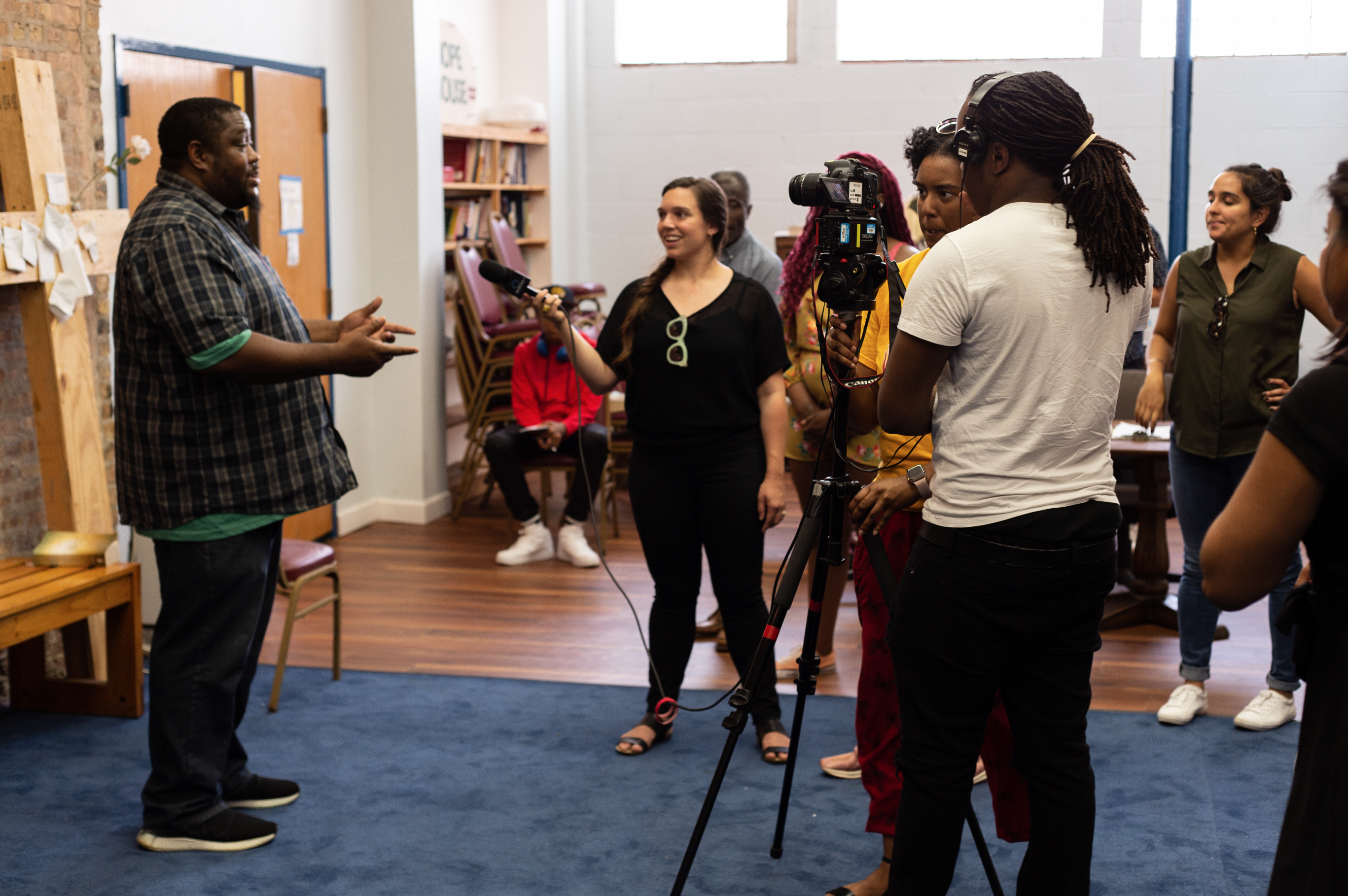 A student interviews a man at Hope House, a transitional home in Chicago, during Free Spirit Media's News West summer program. Image by Claire Seaton. United States, 2019. A student interviews a man at Hope House, a transitional home in Chicago, during Free Spirit Media's News West summer program. Image by Claire Seaton. United States, 2019.