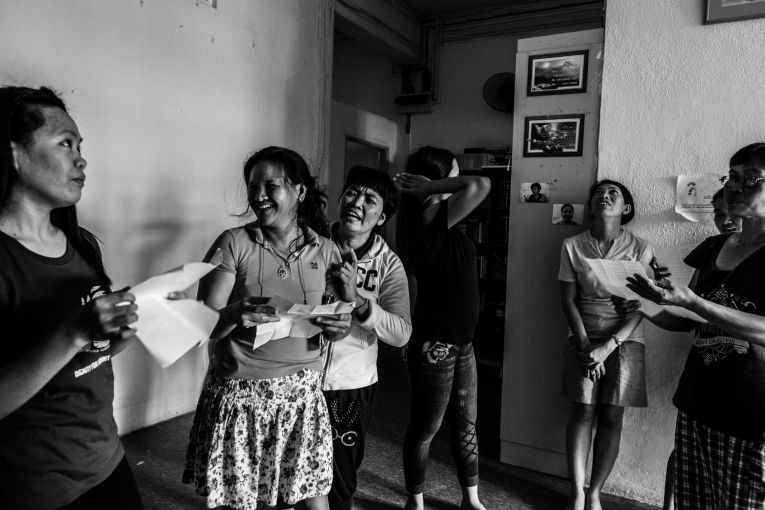 Runaway migrant workers practiced a song inside the shelter to stay active despite their painful situations. Image by Xyza Bacani. Singapore, 2016. Runaway migrant workers practiced a song inside the shelter to stay active despite their painful situations. Image by Xyza Bacani. Singapore, 2016.