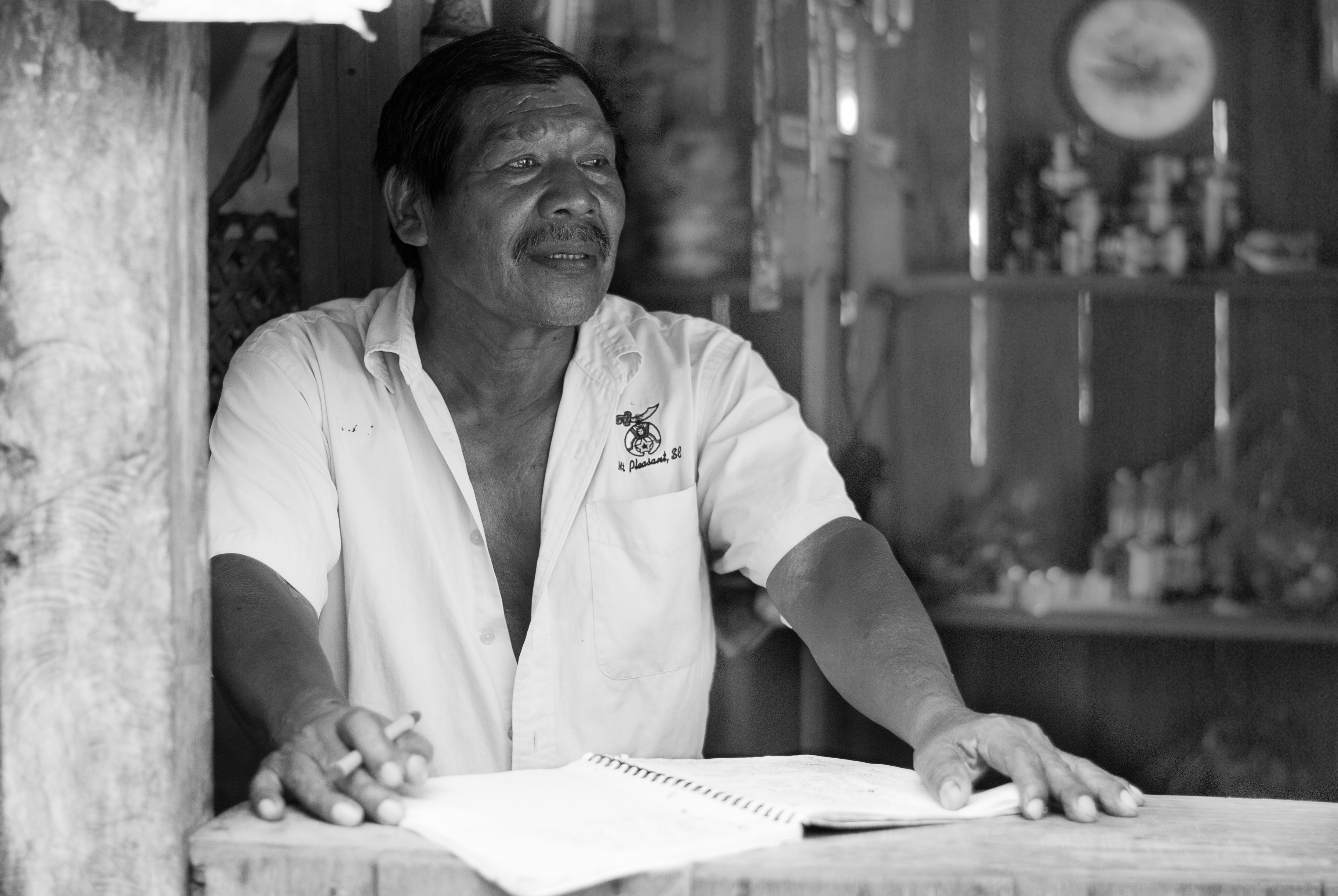 Roberto, 71, stands in the grocery store he opened in Yorkín. He uses his mobile phone to call and message family members and friends in his community. Image by Diana Crandall. Costa Rica, 2015. Media file: finalyorkin2.jpg