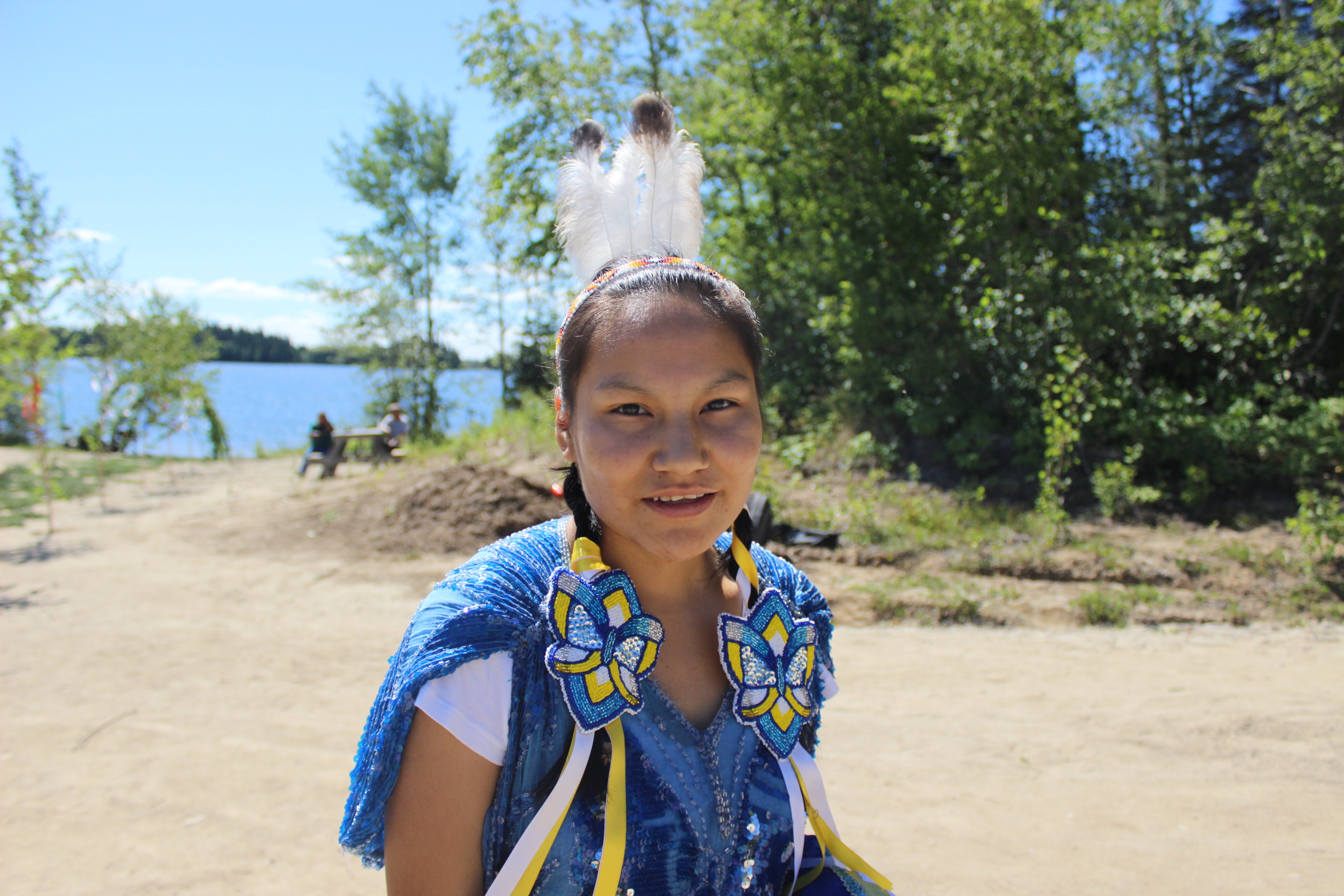 A young woman adorned in formal ceremonial clothes for the arrival of dignitaries. She and her peers will dance for the visiting archbishops. Image by Dillon DeWitt. Canada, 2016. Ceremonial_dress
