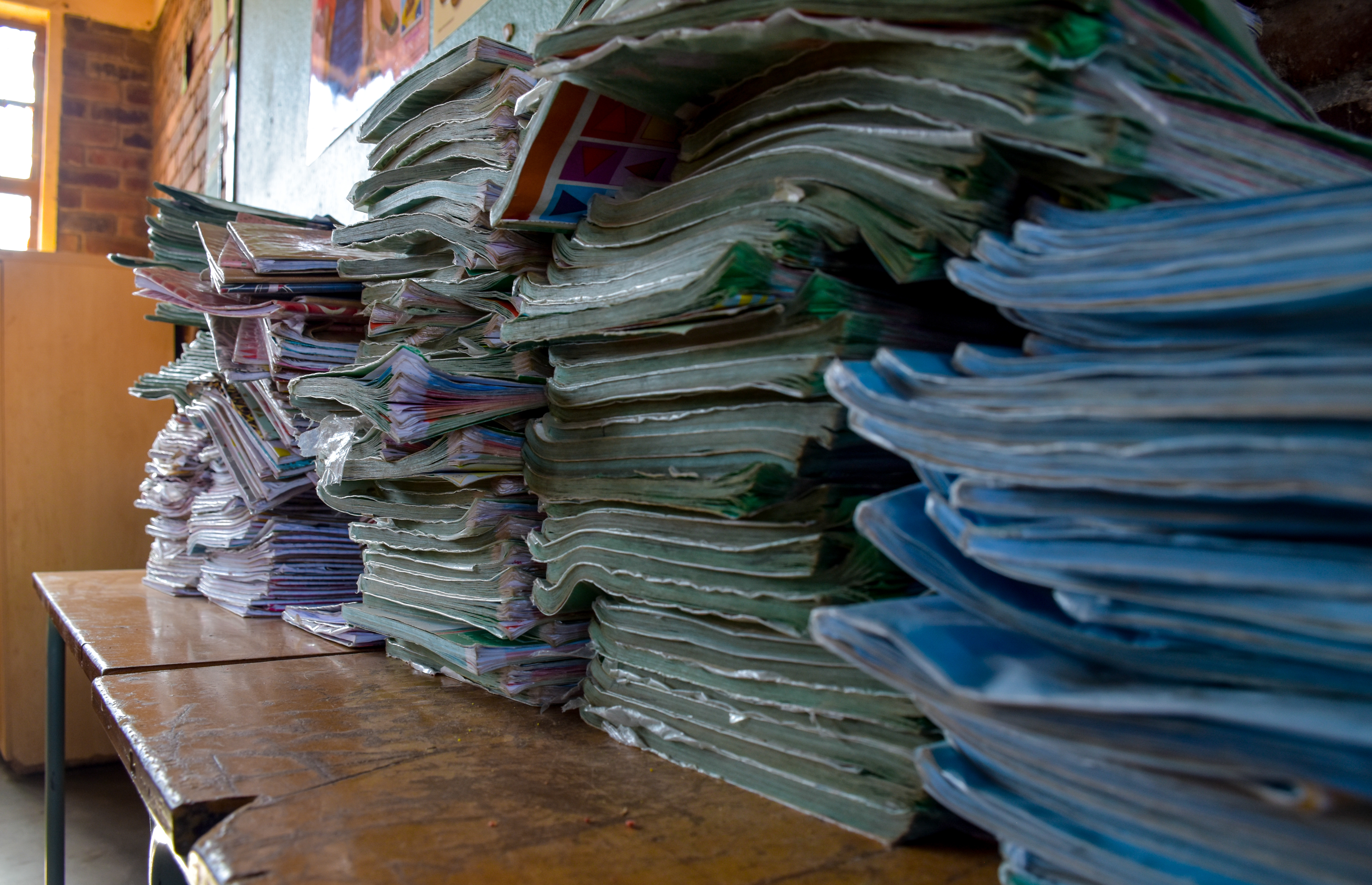 A pile of old textbooks at Utjane Primary School in Limpopo. Many rural schools lack libraries as well as other components of a "basic education." Image by Adam Yates. South Africa, 2018. A pile of old textbooks at Utjane Primary School in Limpopo. Many rural schools lack libraries as well as other components of a "basic education." Image by Adam Yates. South Africa, 2018.