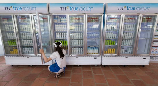 A worker takes care of inventory at a TH Truemart factory store in Nghia Son, Vietnam. Image by Mark Hoffman. Vietnam, 2019. A worker takes care of inventory at a TH Truemart factory store in Nghia Son, Vietnam. Image by Mark Hoffman. Vietnam, 2019.