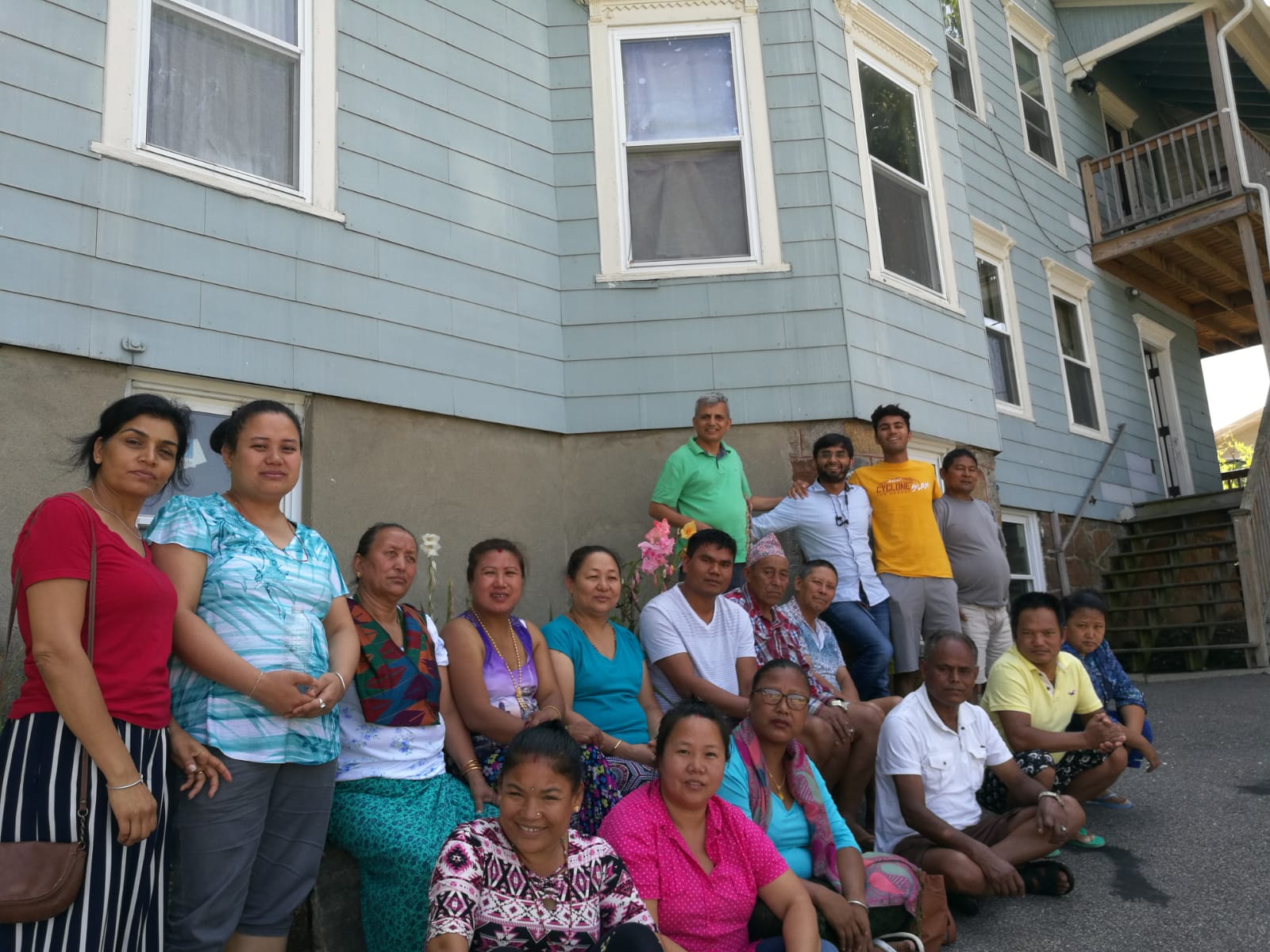 A group of Bhutanese refugees residing in the greater Worcester area with Purna Neupane (fourth from right), Harvard Medical School researcher Dr. Nadeem Kasmani (third from right), and Washington University in St. Louis student Ani Gururaj (second from right). Image courtesy of Ani Gururaj. Massachusetts, 2018. A group of Bhutanese refugees residing in the greater Worcester area with Purna Neupane (fourth from right), Harvard Medical School researcher Dr. Nadeem Kasmani (third from right), and Washington University in St. Louis student Ani Gururaj (second from right). Image courtesy of Ani Gururaj. Massachusetts, 2018.