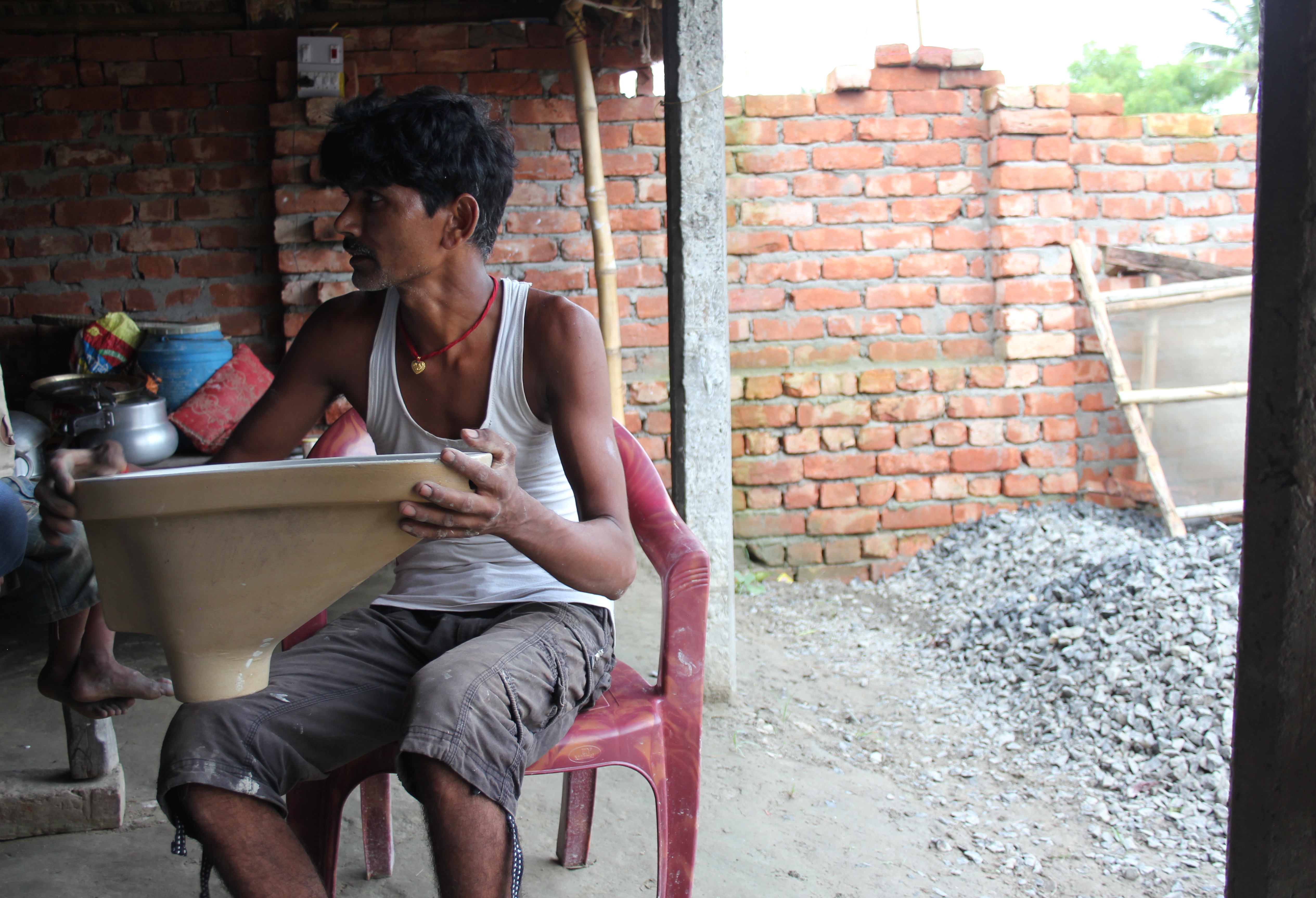 Pramod Kumar explains a new toilet design in rural Bihar, India. Image by Ann Schraufnagel. India, 2015. Media file: img_5503.jpg