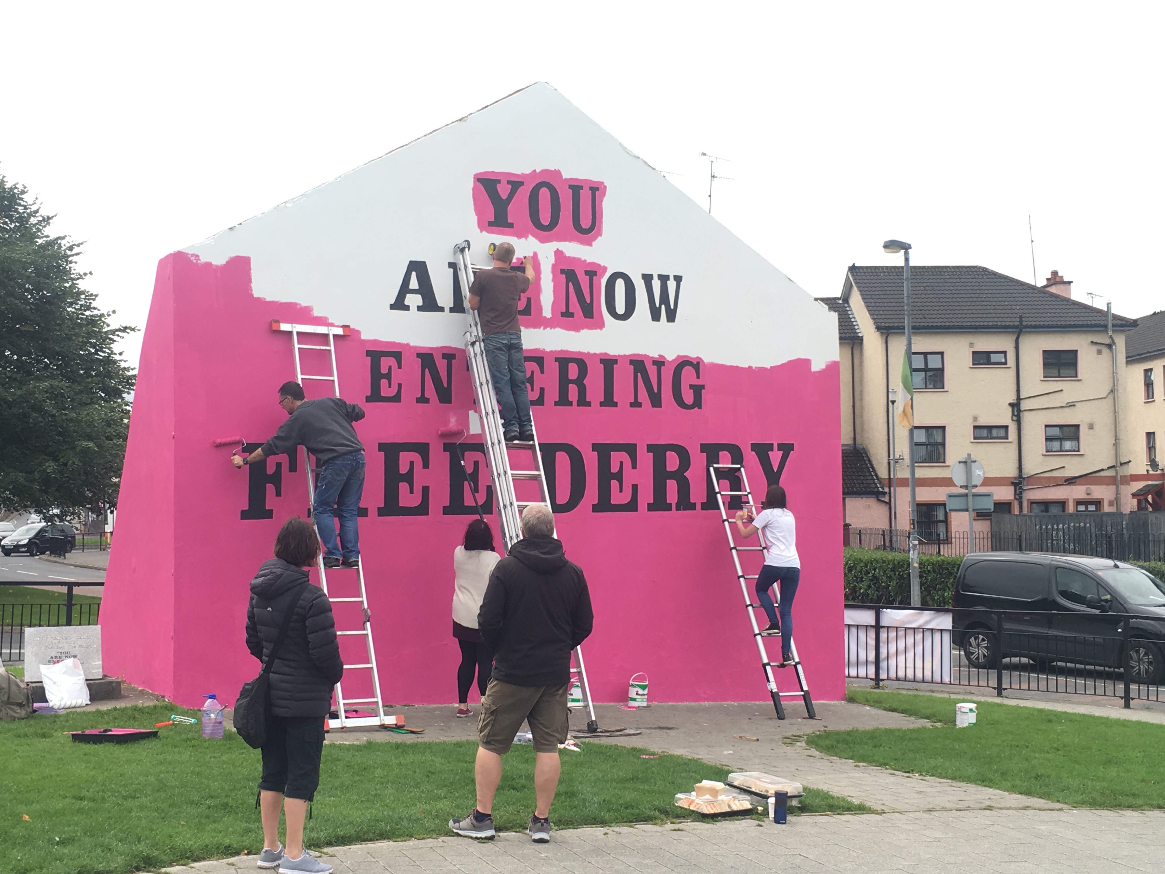 “You Are Now Entering Free Derry” Mural. The Free Derry mural, signifying police ‘no go’ zones during The Troubles, is painted pink for Pride. Photo by Julia Canney. Northern Ireland, 2018. “You Are Now Entering Free Derry” Mural. The Free Derry mural, signifying police ‘no go’ zones during The Troubles, is painted pink for Pride. Photo by Julia Canney. Northern Ireland, 2018.