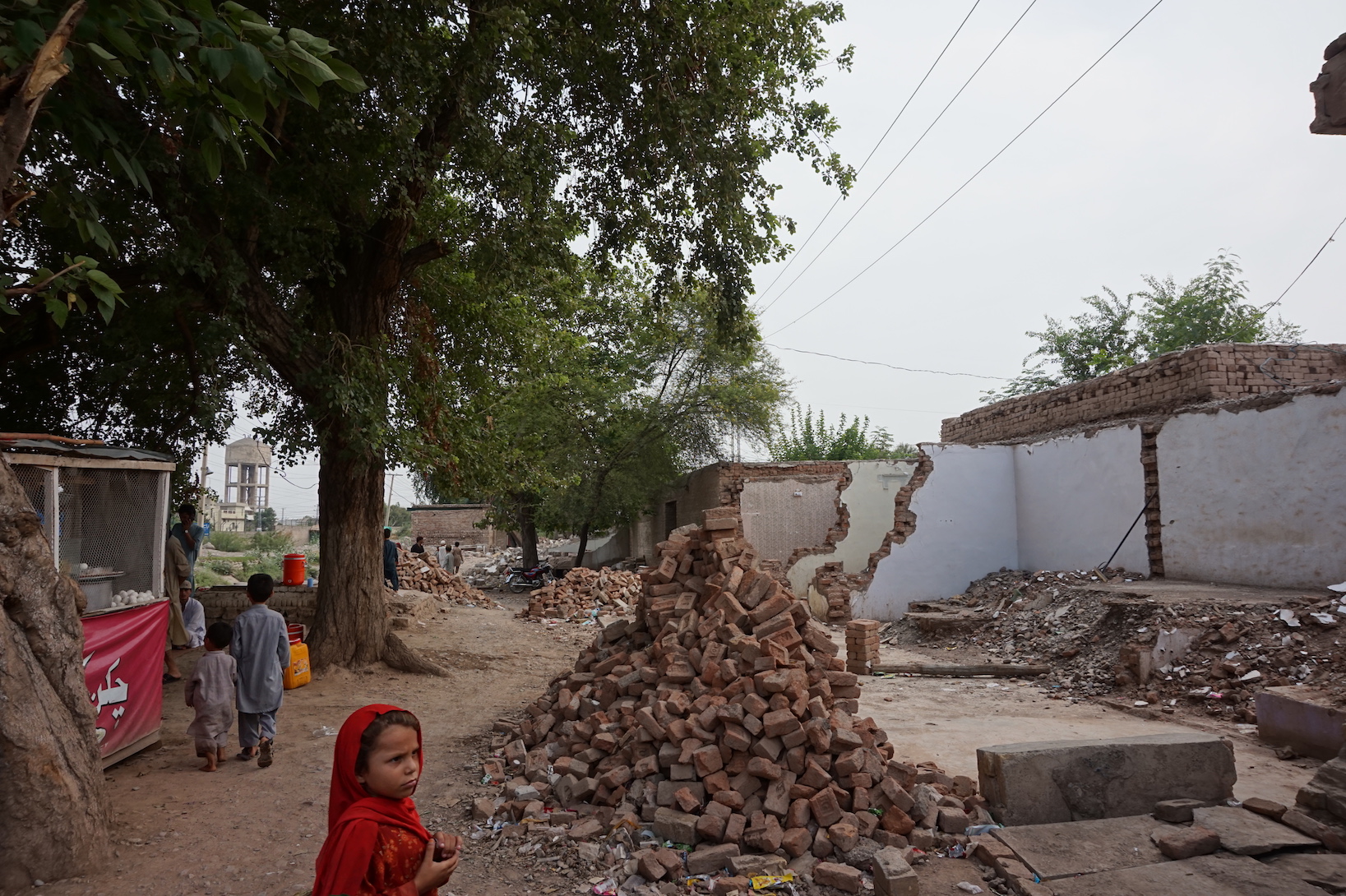 A child watches as a row of shops is demolished by authorities for collective punishment in Khyber Agency, in the Federally Administered Tribal Areas. Image by Umar Farooq. Pakistan, 2017. A child watches as a row of shops is demolished by authorities for collective punishment in Khyber Agency, in the Federally Administered Tribal Areas. Image by Umar Farooq. Pakistan, 2017.