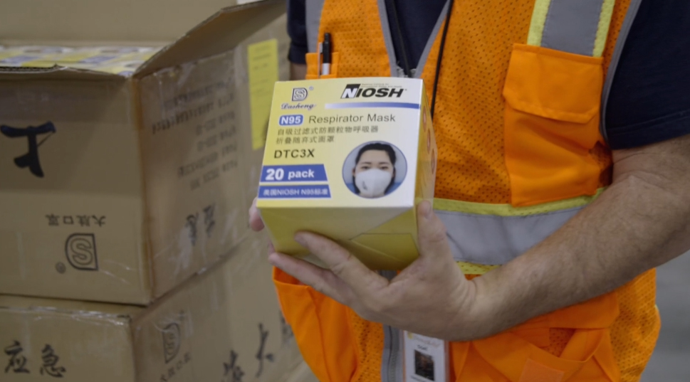 After a long delay, N95 masks are delivered to the United States from China. Image by PBS Frontline. United States, 2020. After a long delay, N95 masks are delivered to the United States from China. Image by PBS Frontline. United States, 2020.