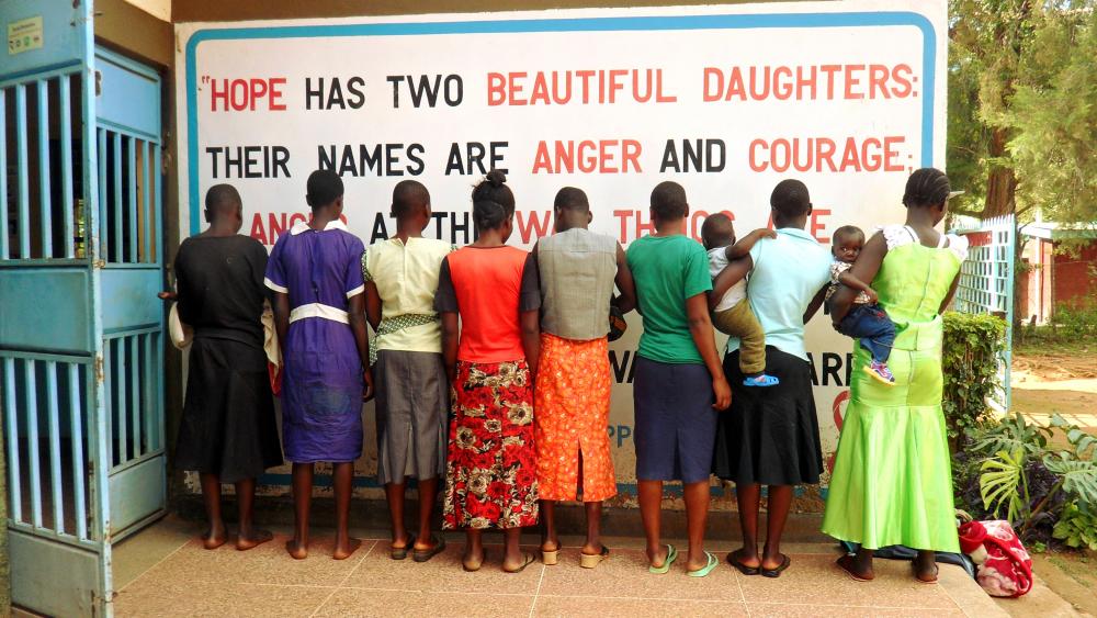 Girls and young women under the care of the Rural Education and Economic Enhancement Program in Butula, Busia County, Kenya. Quote on wall: "Hope has two beautiful daughters; their names are Anger and Courage. Anger at the way things are, and Courage to see that they do not remain as they are." Photo from the project by Adiba Khan and Paul Nevin, University of Washington student fellows who reported on maternal healthcare in Kenya. Image by Adiba Khan. Kenya, 2014. Media file: photo_untold_story_khan.jpg