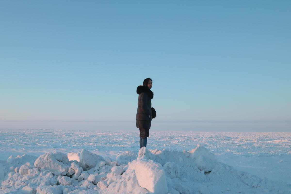 Coffee & Quaq podcast host Alice Qannik Glenn overlooks the frozen Arctic Ocean in February. Image by Jenna Kunze. United States, 2020. Coffee & Quaq podcast host Alice Qannik Glenn overlooks the frozen Arctic Ocean in February. Image by Jenna Kunze. United States, 2020.