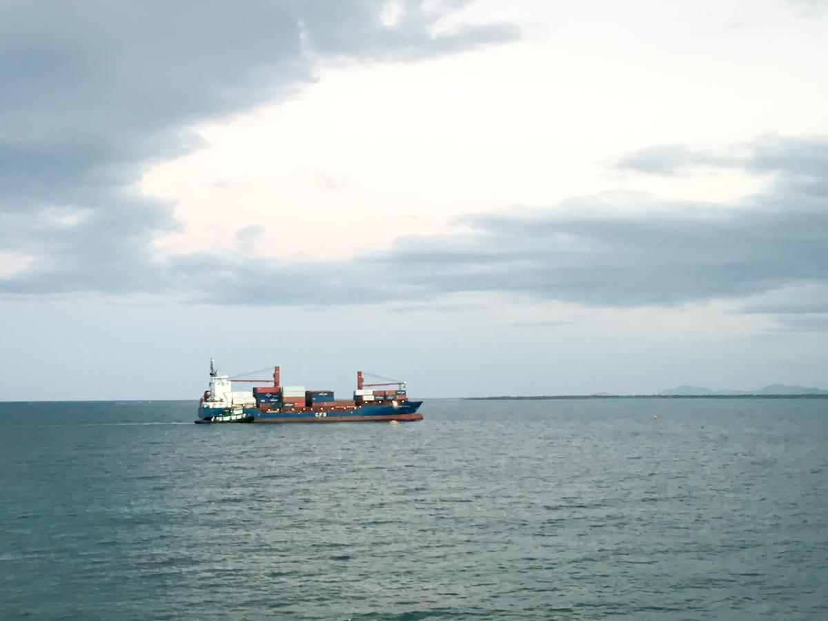 A ship waits to dock off Haiti's Northern coast at Cap-Haïtien. Image by Jacob Kushner. Haiti, 2019. A ship waits to dock off Haiti's Northern coast at Cap-Haïtien.