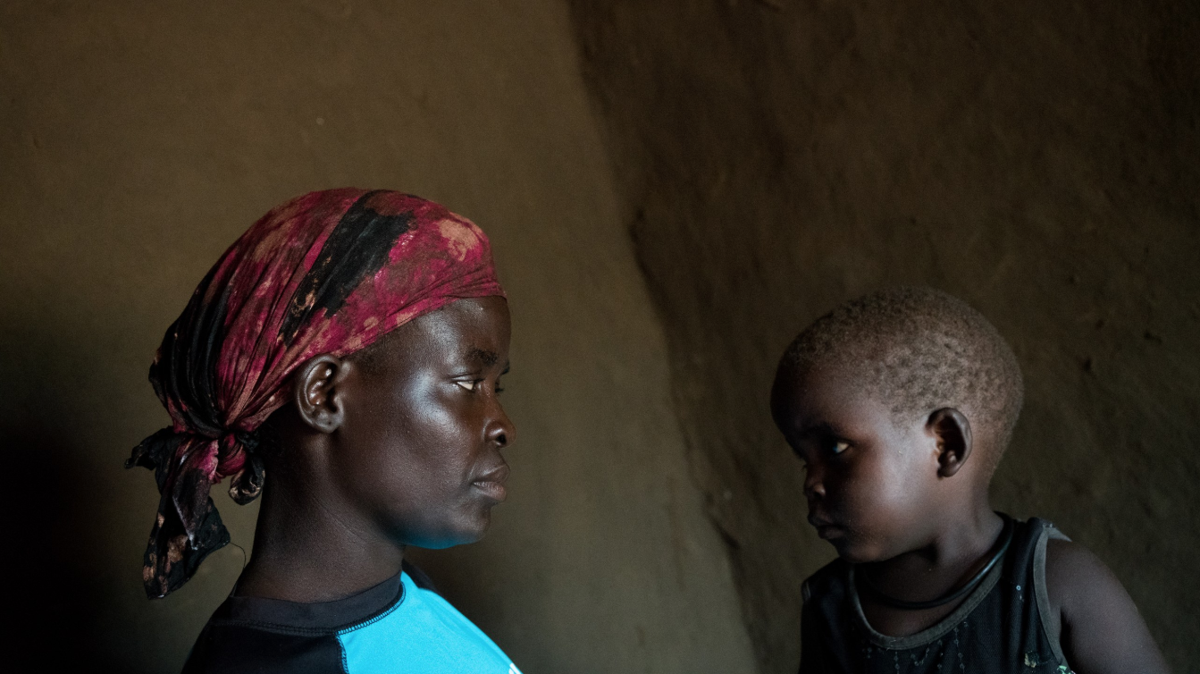 Lilias Diria with her son Abraham, age 2, in their home in the Bidi Bidi settlement in Uganda, June 25, 2019. Image by Adriane Ohanesian. Uganda, 2019. Lilias Diria with her son Abraham, age 2, in their home in the Bidi Bidi settlement in Uganda, June 25, 2019. Image by Adriane Ohanesian. Uganda, 2019.
