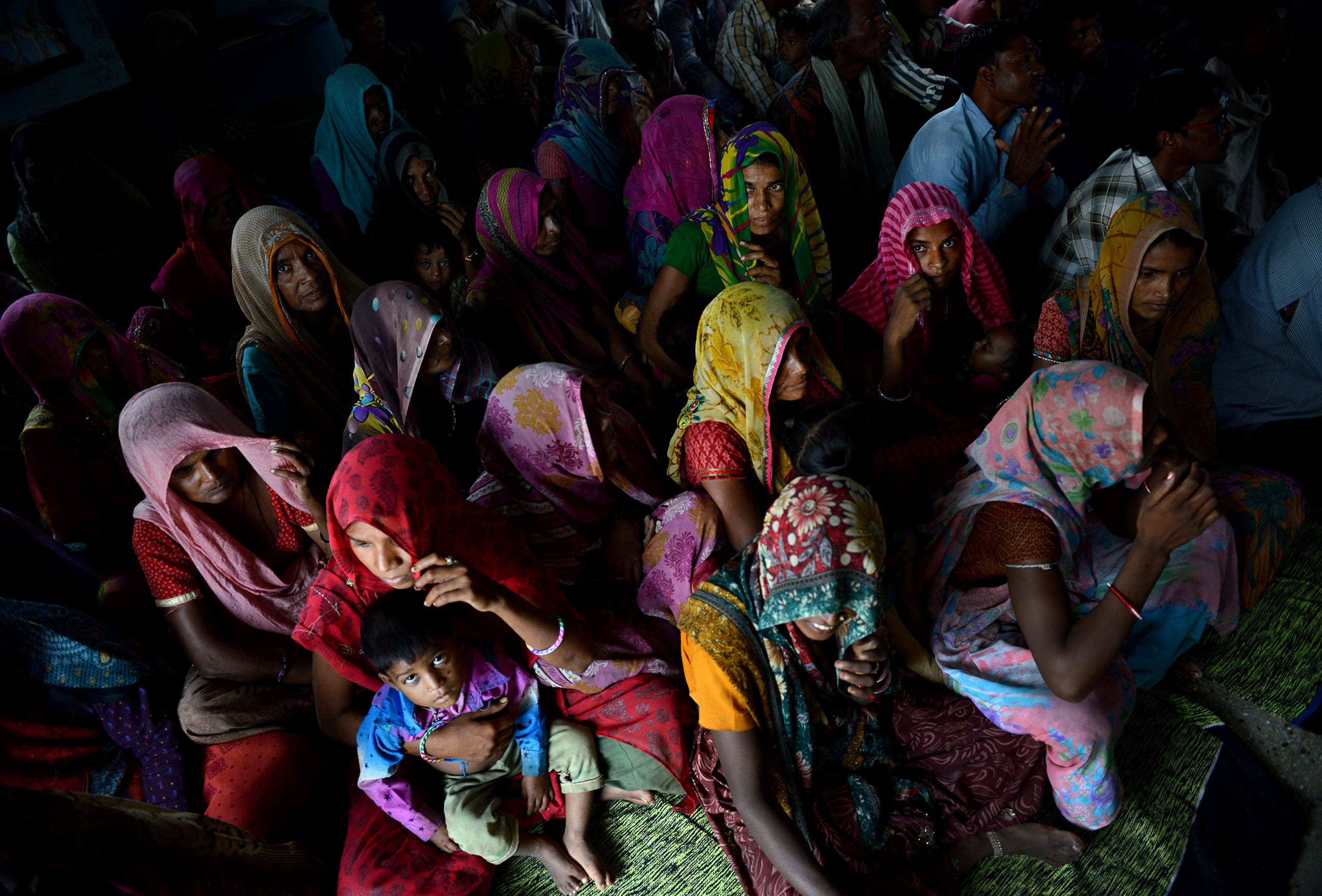 Residents of Tuvar gather in their schoolhouse to hear about the potential of bringing solar-powered electricity to the village. The village in rural northwestern India uses kerosene and firewood for energy. Image by Michael Henninger. India, 2016. powered electricity to the village. The village in rural northwestern India uses kerosene and firewood for energy. Image by Michael Henninger. India, 2016.