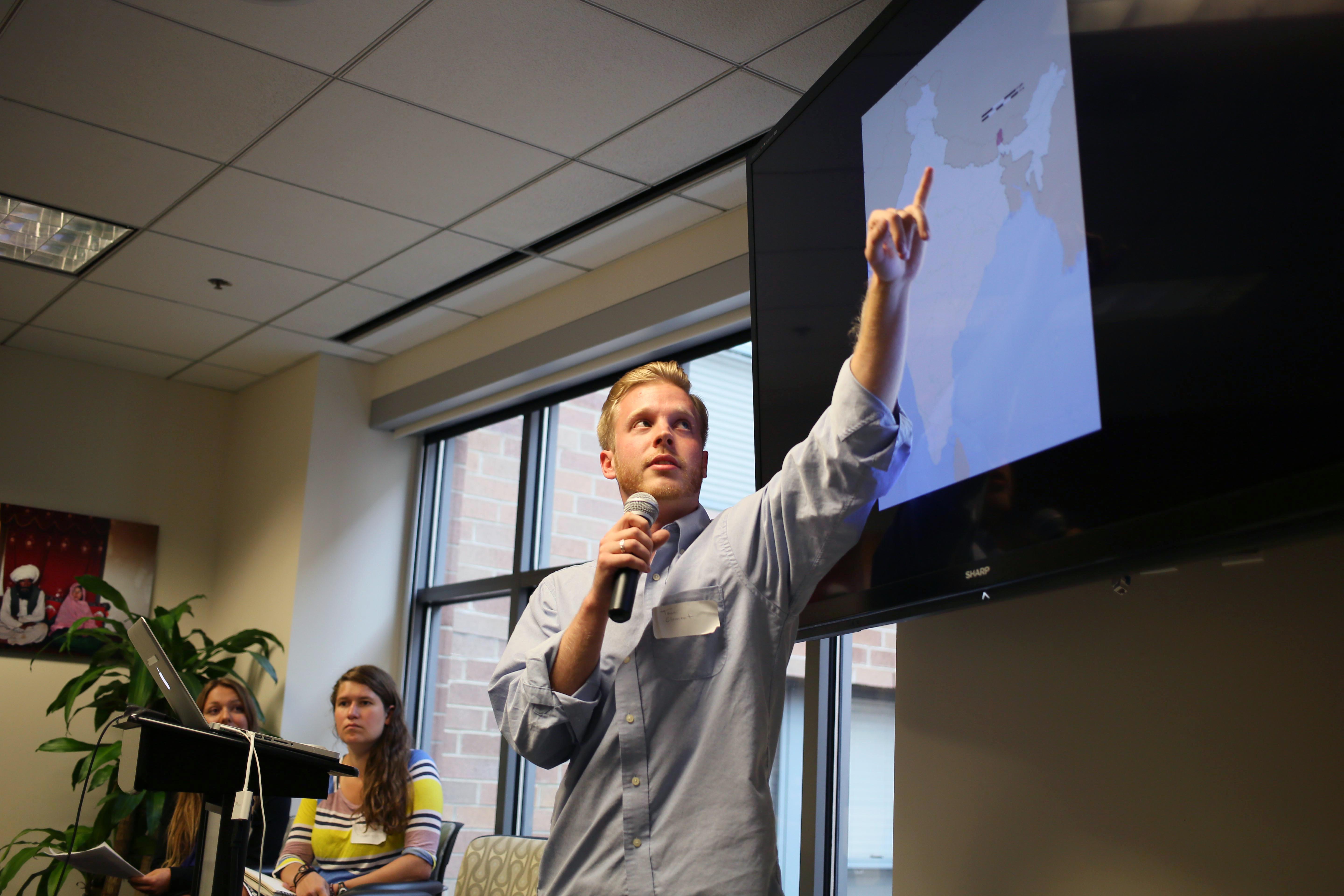 Guilford College student fellow Tom Clement presents his project on damming a sacred river in India. Image by Meghan Dhaliwal. Washington, DC, 2014.