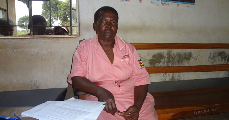 Kirya Beatrice, a midwife, after finishing her work. For the past month, she has been the only medical staff working at Nangonde Health Center II. There are supposed to be between three and four medical personnel at each health center II. Image by Jae Lee. Uganda, 2015. Media file: uganda-pulitzer-oct2015-news.jpg