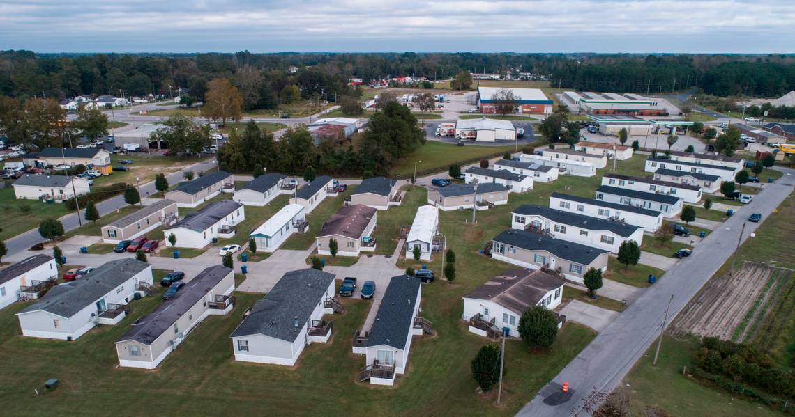 Abbott Park, a mobile home park in Lumberton, N.C., pictured here on Friday, Oct. 16, 2020, is owned by Time Out Communities. According to an Associated Press report, the company bought almost all of the mobile home parks in Lumberton after Hurricane Florence. Researchers examining the health effects of rising temperatures in counties like Robeson, which is located in the Sandhills region of the state, are looking at how higher temperatures can impact residents of mobile home parks and exacerbate social vulnerabilities. Image by Julia Wall / The News & Observer. United States, 2020. Abbott Park, a mobile home park in Lumberton, N.C., pictured here on Friday, Oct. 16, 2020, is owned by Time Out Communities. According to an Associated Press report, the company bought almost all of the mobile home parks in Lumberton after Hurricane Florence. Researchers examining the health effects of rising temperatures in counties like Robeson, which is located in the Sandhills region of the state, are looking at how higher temperatures can impact residents of mobile home parks and exacerbate social…