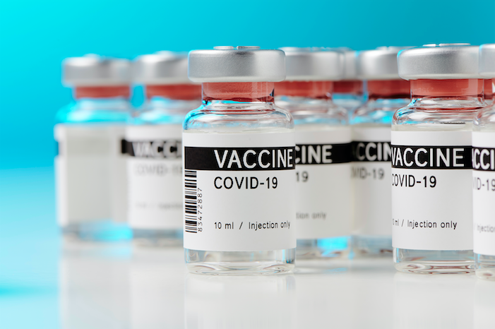 Ampoules with a COVID-19 vaccine on a laboratory bench. Image by M-Foto/Shutterstock. 2020. Ampoules with a COVID-19 vaccine on a laboratory bench. Image by M-Foto/Shutterstock. 2020.