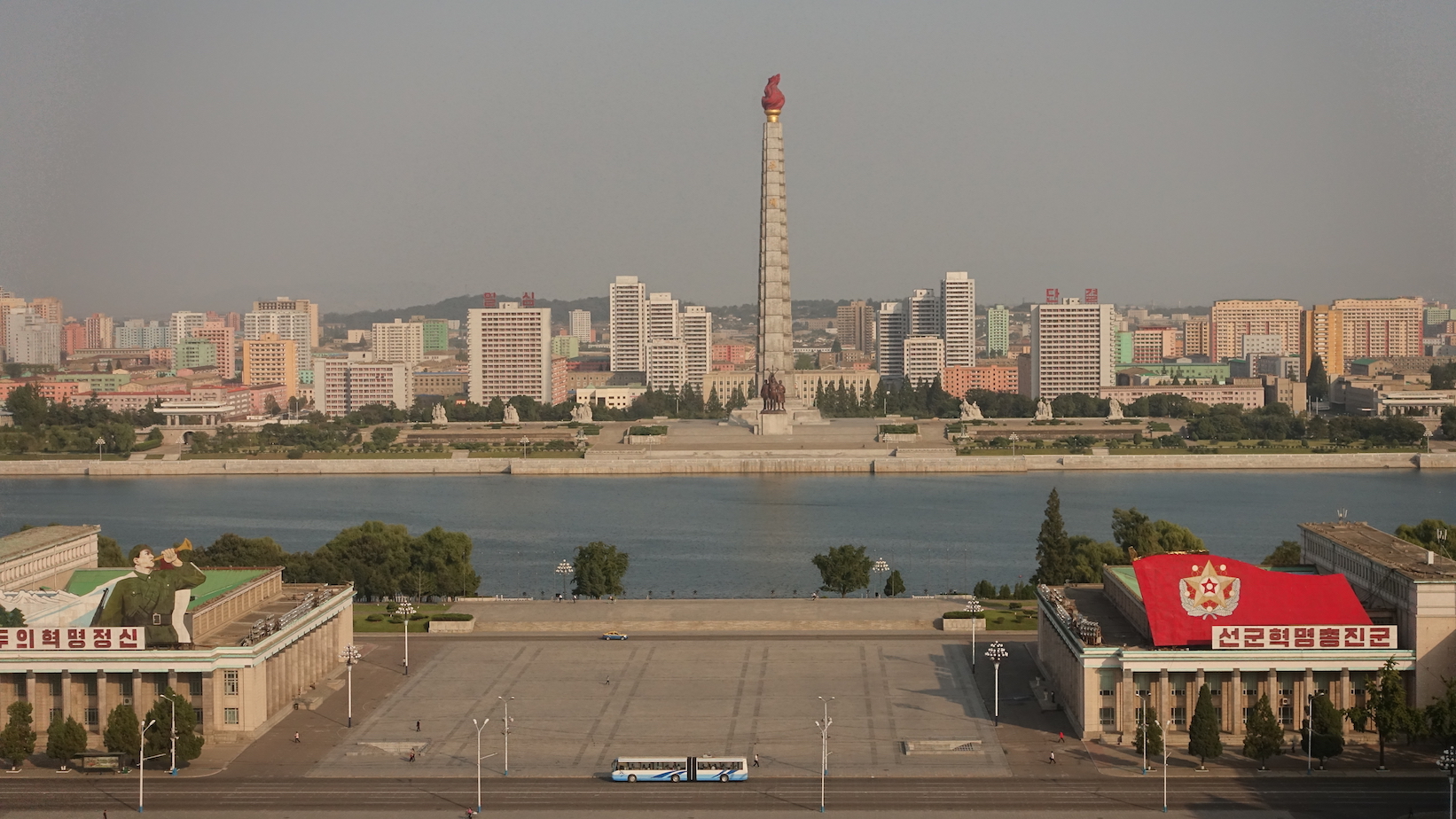 Kim Il-sung Square, against a backdrop of the Taedong river and the Juche Tower on the other side. Image by Laya Maheshwari. North Korea, 2016. Kim Il-sung Square, against a backdrop of the Taedong river and the Juche Tower on the other side. Photo by Laya Maheshwari. Image by Laya Maheshwari. North Korea, 2016.