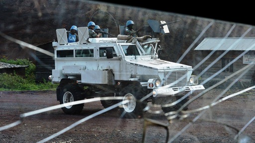 An armored vehicle of the MONUSCO (United Nations Organization Stabilization mission in the Democratic Republic of the Congo) is pictured through broken glass near Kibati, near Goma on September 4. Media file: 179483756_video_embed.jpg