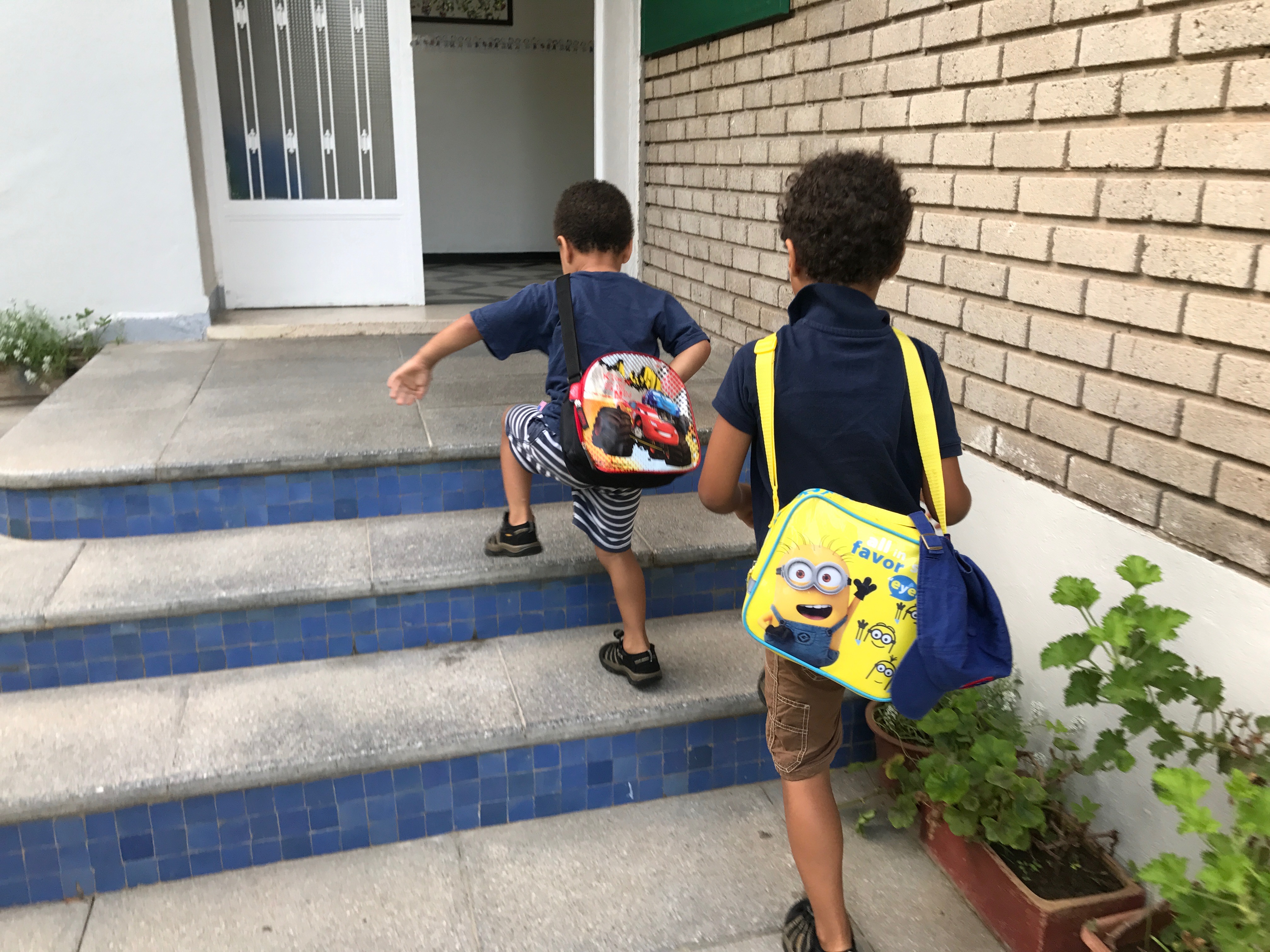 The author's sons, ages 5 and 3, walk up the stairs at their private French school in Morocco. The boys are autistic. Image by Jackie Spinner. Morocco, 2017. The author's sons, ages 5 and 3, walk up the stairs at their private French school in Morocco. The boys are autistic. Image by Jackie Spinner. Morocco, 2017.