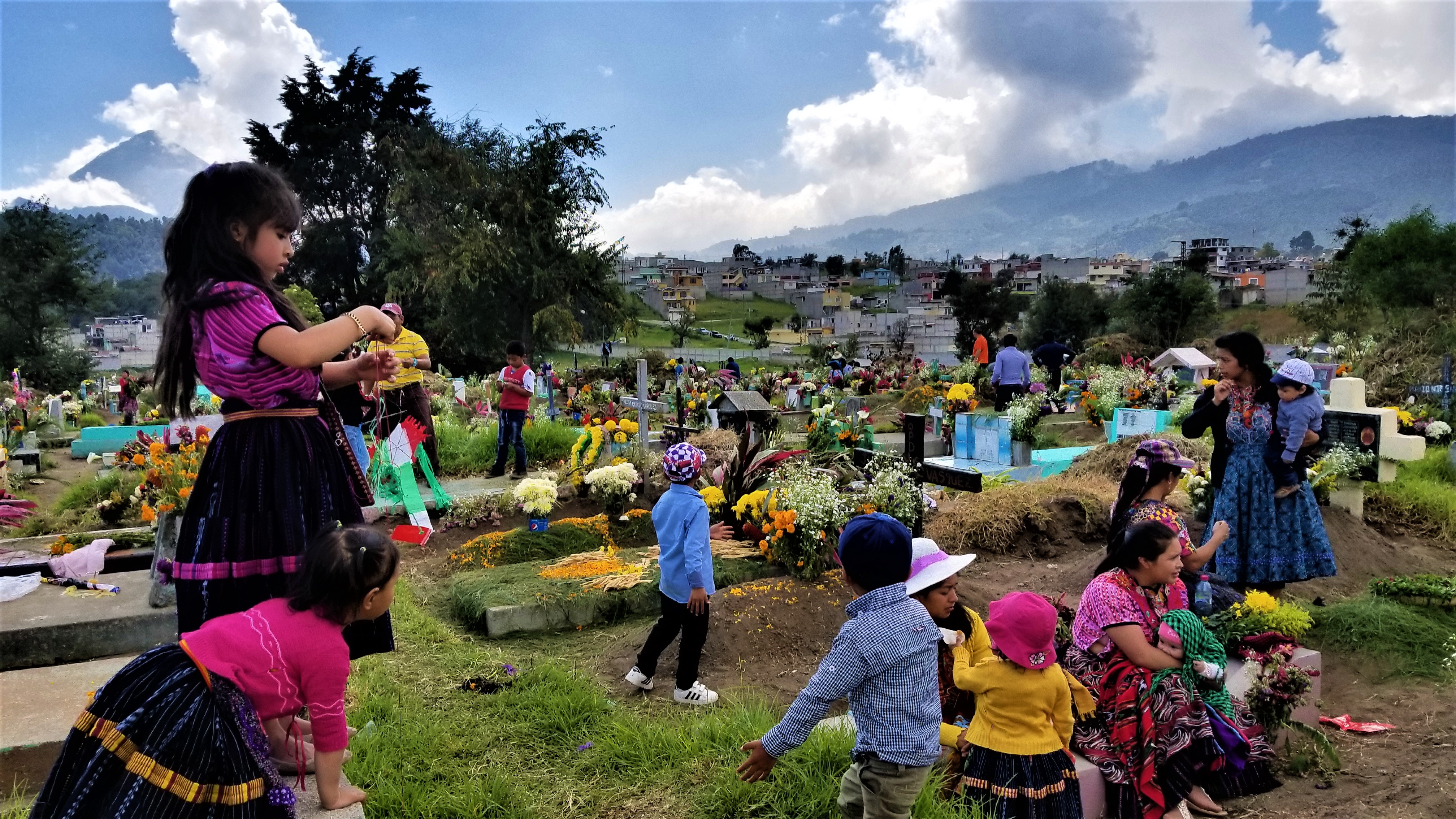 Cemeteries throughout Latin America, such as this one in Quetzaltenango, Guatemala, come to life when families decorate the graves of their loved ones with candles, fresh cut grass and flowers. For two days they pray, eat and remember their ancestors in honor of Day of the Dead. Image by Kristian Hernandez. Guatemala, 2018. Cemeteries throughout Latin America, such as this one in Quetzaltenango, Guatemala, come to life when families decorate the graves of their loved ones with candles, fresh cut grass and flowers. For two days they pray, eat and remember their ancestors in honor of Day of the Dead. Image by Kristian Hernandez. Guatemala, 2018.