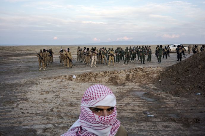 Sunni fighters who oppose the Islamic State take up formation along the front line near the ISIS-controlled village of Haj Ali, south of Mosul. Image by Moises Saman/Magnum Photos. Iraq, 2015. Sunni fighters who oppose the Islamic State take up formation along the front line near the ISIS-controlled village of Haj Ali, south of Mosul. Image by Moises Saman/Magnum Photos. Iraq, 2015.
