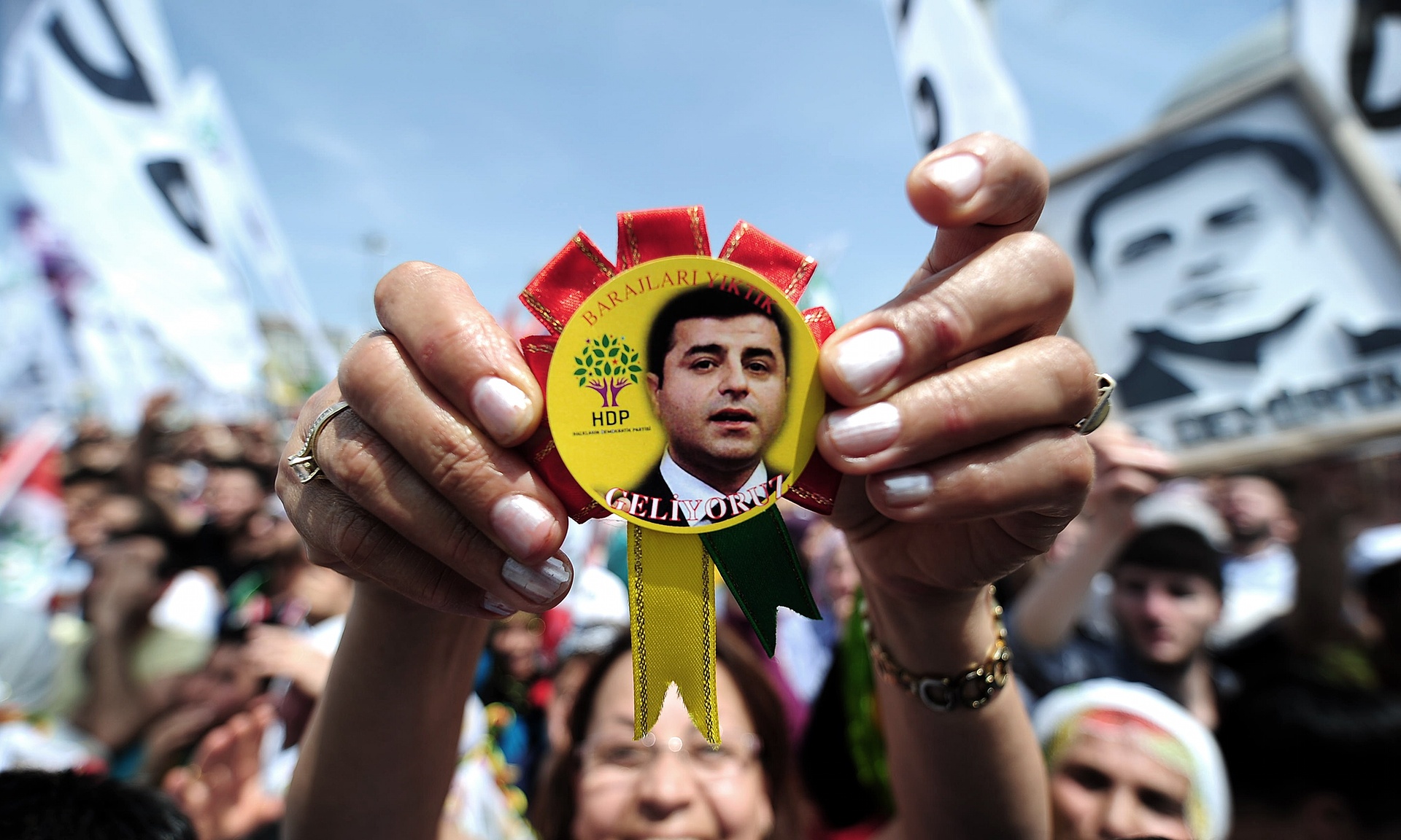 A woman shows a badge bearing the face of Selahattin Demirtaş, leader of the Peoples’ Democratic party, during an election rally in May. The party went on to win 80 seats in the Turkish parliament. Image by Ozan Kose/AFP/Getty Images. Media file: 4256.jpg