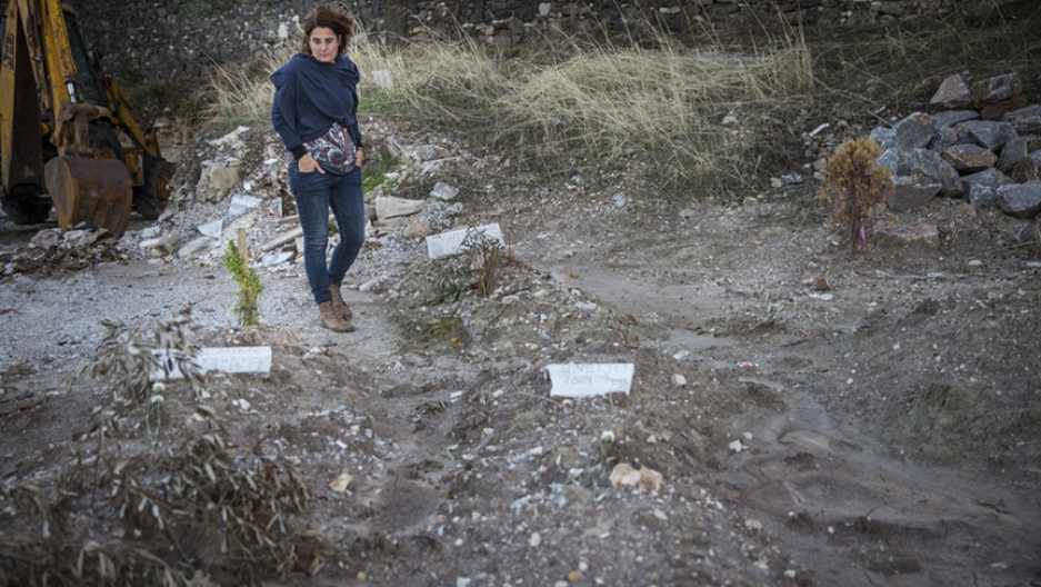 Efi Latsoudi, a longtime advocate for immigrant rights on Lesbos, at the Saint Panteleimon cemetery, where dozens of people who died trying to cross the sea to Greece have been buried over the past years. Image by Jodi Hilton. Greece, 2015.