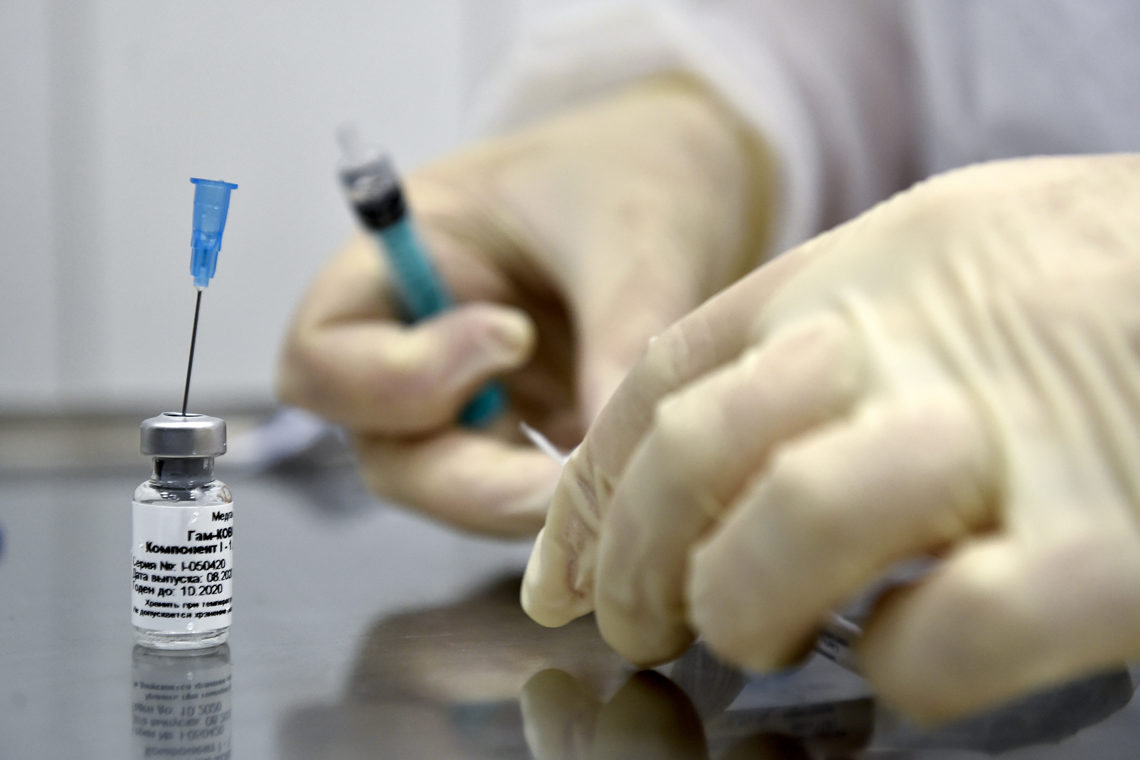A nurse prepares to inoculate volunteer Ilya Dubrovin, 36, with Russia's new coronavirus vaccine in a post-registration trials at a clinic in Moscow on September 10, 2020. Russia announced last month that its vaccine, named "Sputnik V" after the Soviet-era satellite that was the first launched into space in 1957, had already received approval. The vaccine was developed by the Gamaleya research institute in Moscow in coordination with the Russian Defence Ministry. Image by Natalia Kolesnikova/AFP. Russia, 2020. A nurse prepares to inoculate volunteer Ilya Dubrovin, 36, with Russia's new coronavirus vaccine in a post-registration trials at a clinic in Moscow on September 10, 2020. Russia announced last month that its vaccine, named "Sputnik V" after the Soviet-era satellite that was the first launched into space in 1957, had already received approval. The vaccine was developed by the Gamaleya research institute in Moscow in coordination with the Russian Defence Ministry. Image by Natalia Kolesnikova/AFP. Russia,…