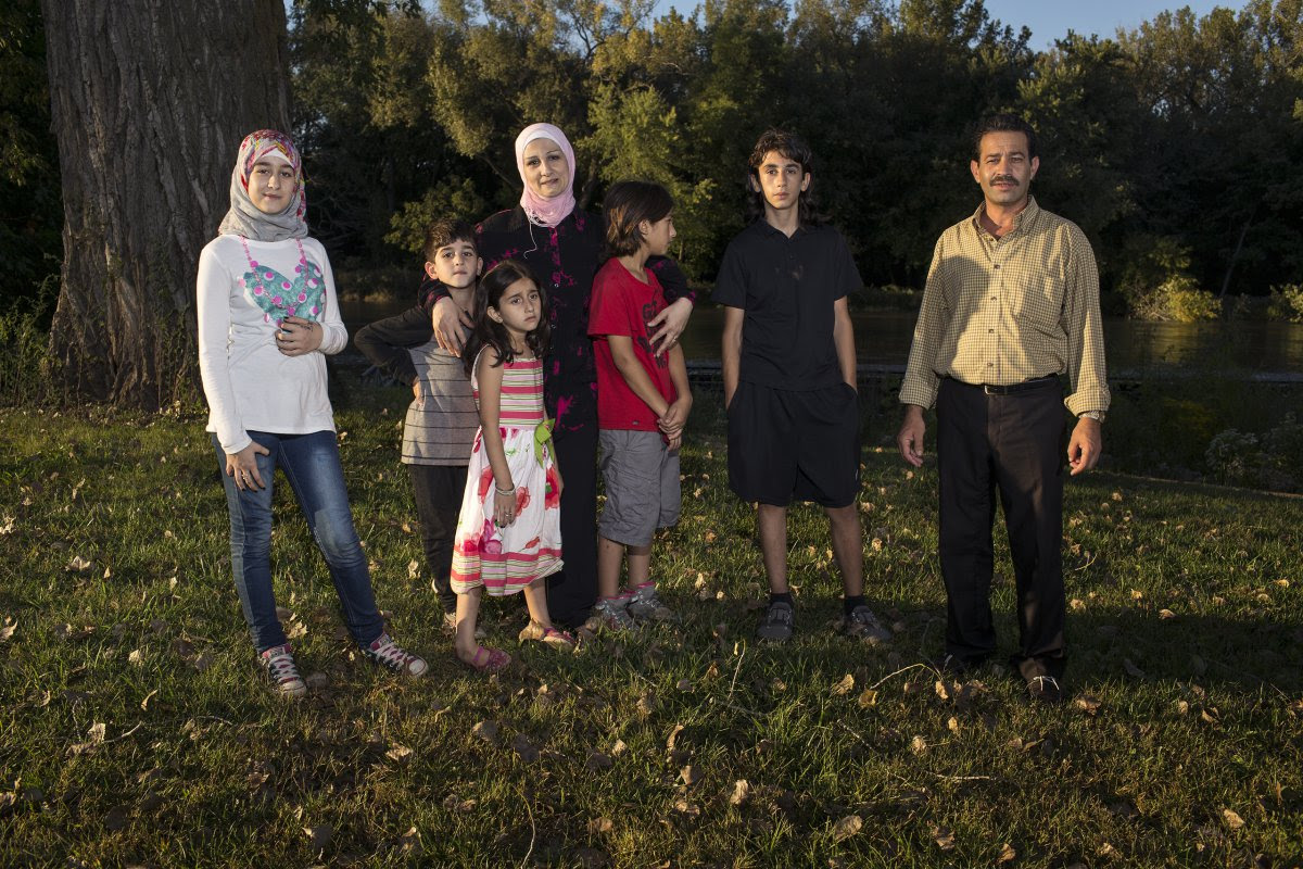 Ghazweh and Abdul Fattah at a park in Des Moines with their children, from left to right: Sedra, Mutaz, Hala, Haidar and Nazeer. Image by Danny Wilcox Frazier—VII for TIME. Des Moines, IA, 2016. Ghazweh and Abdul Fattah at a park in Des Moines with their children, from left to right: Sedra, Mutaz, Hala, Haidar and Nazeer. Image by Danny Wilcox Frazier—VII for TIME. Des Moines, IA, 2016.
