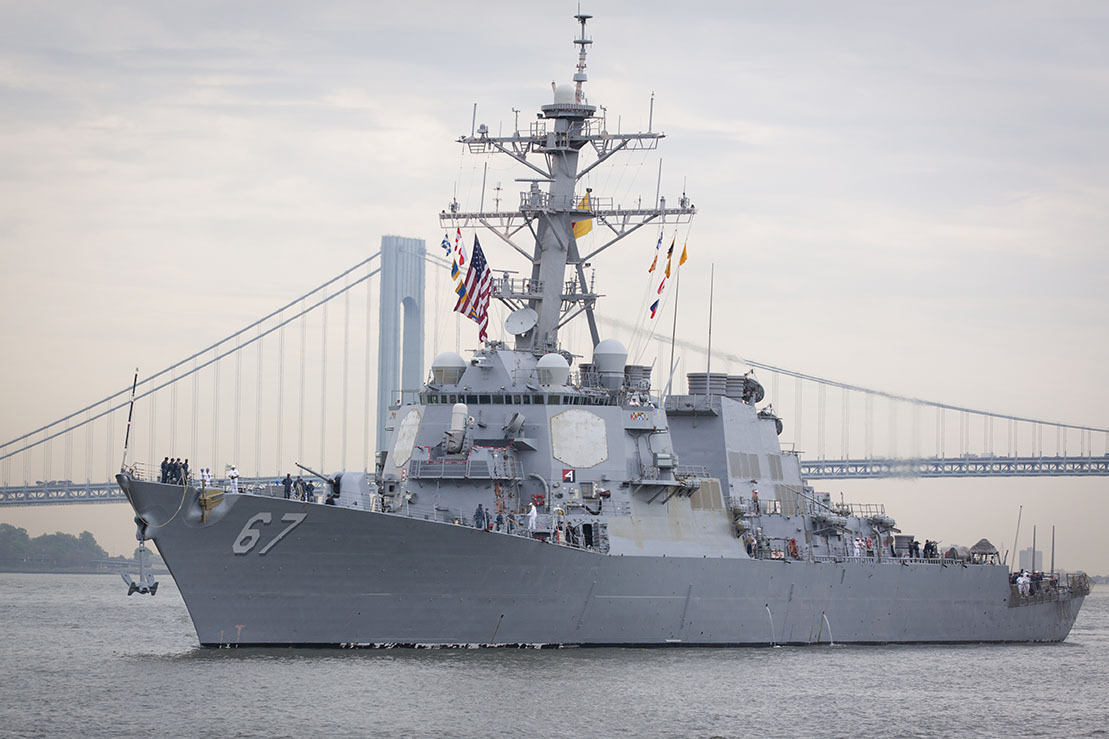Guided-missile destroyer USS Cole (DDG 067) approaching Sullivan's Piers with the Verrazzano-Narrows Bridge in the background. The ship is part of Fleet Week NY. Image by Glynnis Jones / Shutterstock.com. United States, 2014. Guided-missile destroyer USS Cole (DDG 067) approaching Sullivan's Piers with the Verrazzano-Narrows Bridge in the background. The ship is part of Fleet Week NY. Image by Glynnis Jones / Shutterstock.com. United States, 2014.