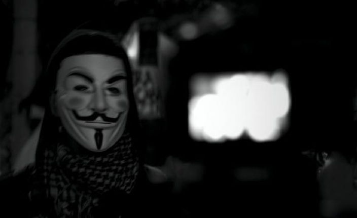 A masked protester is interviewed by state news media in Rio de Janeiro. The photograph is part of the project by Wake Forest University's Jawad Wahabzada whose reporting examines the protests against the Brazilian government and its mega-spending on FIFA World Cup projects. Image by Jawad Wahabzada. Brazil, 2013.