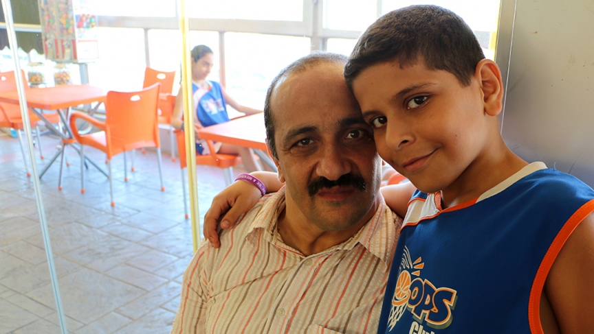 Ahmad and his dad Ali at Hoops, an indoor basketball school. Ahmad's classes here are made possible by a Lebanese NGO called Nawaya. Image by Ari Daniel. Lebanon, 2014. Media file: ahmadfeature.jpg