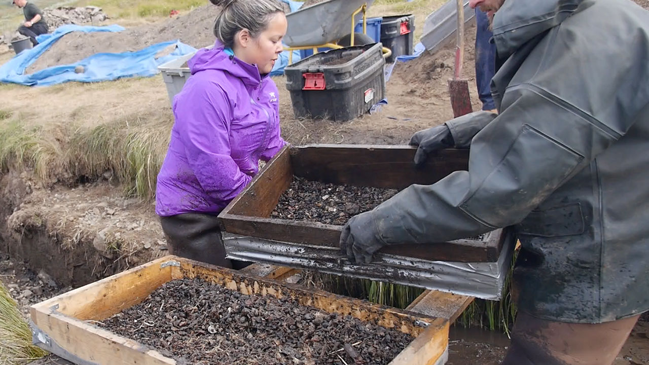 Greenlander Eva Luusi Marcussen-Mølgaard of the University of Greenland in Nuuk (left) washes soil off artifacts. She is one of a handful of students eager to study the archaeology of their homeland. Image by Eli Kintisch. Greenland, 2016. Greenlander Eva Luusi Marcussen-Mølgaard of the University of Greenland in Nuuk (left) washes soil off artifacts. She is one of a handful of students eager to study the archaeology of their homeland. Image by Eli Kintisch. Greenland, 2016.