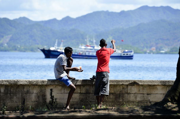 Two men fish in Fiji, which is made up of about 300 islands in the Pacific. The Seattle area is home to Fijians closely watching the effects of climate change on their homeland. Image courtesy of Agence France-Presse/Getty Images. Fiji, 2014. Media file: 1.jpg