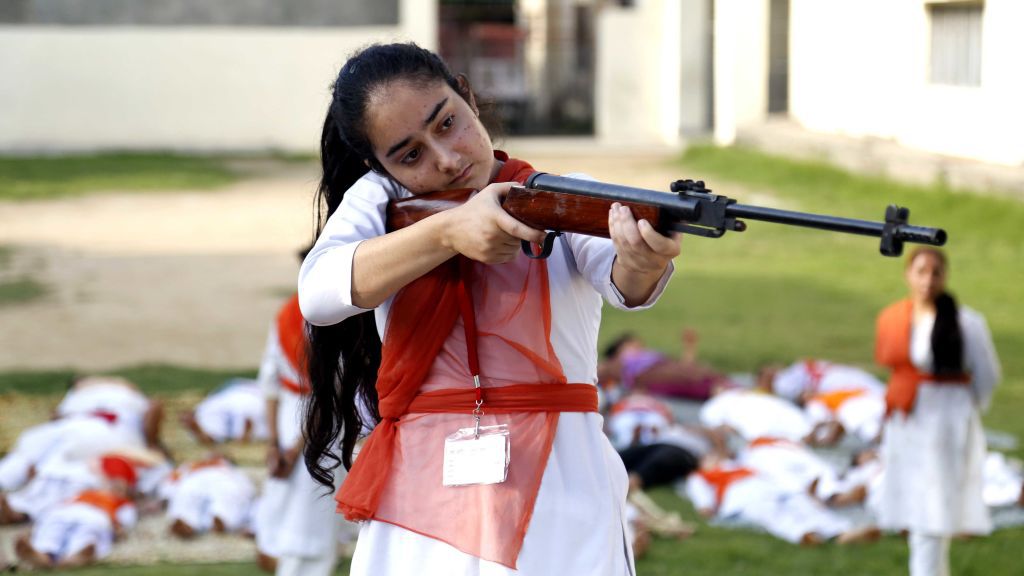Hindu girls of the Durga Vahini, the 'saffron brigade' women's wing of the Hindu hardliner organization Vishwa Hindu Parishad (VHP), participate in a self-defense training camp, on July 7, 2017 in Jammu, India. Due to the increase in crime against women in the country, the young girls are being given training to operate sticks and guns and to develop the skills of self-defence. Image by Nitin Kanotra / Hindustan Times via Getty Images. India, 2017. Hindu girls of the Durga Vahini, the 'saffron brigade' women's wing of the Hindu hardliner organization Vishwa Hindu Parishad (VHP), participate in a self-defense training camp, on July 7, 2017 in Jammu, India. Due to the increase in crime against women in the country, the young girls are being given training to operate sticks and guns and to develop the skills of self-defence. Image by Nitin Kanotra / Hindustan Times via Getty Images. India, 2017.