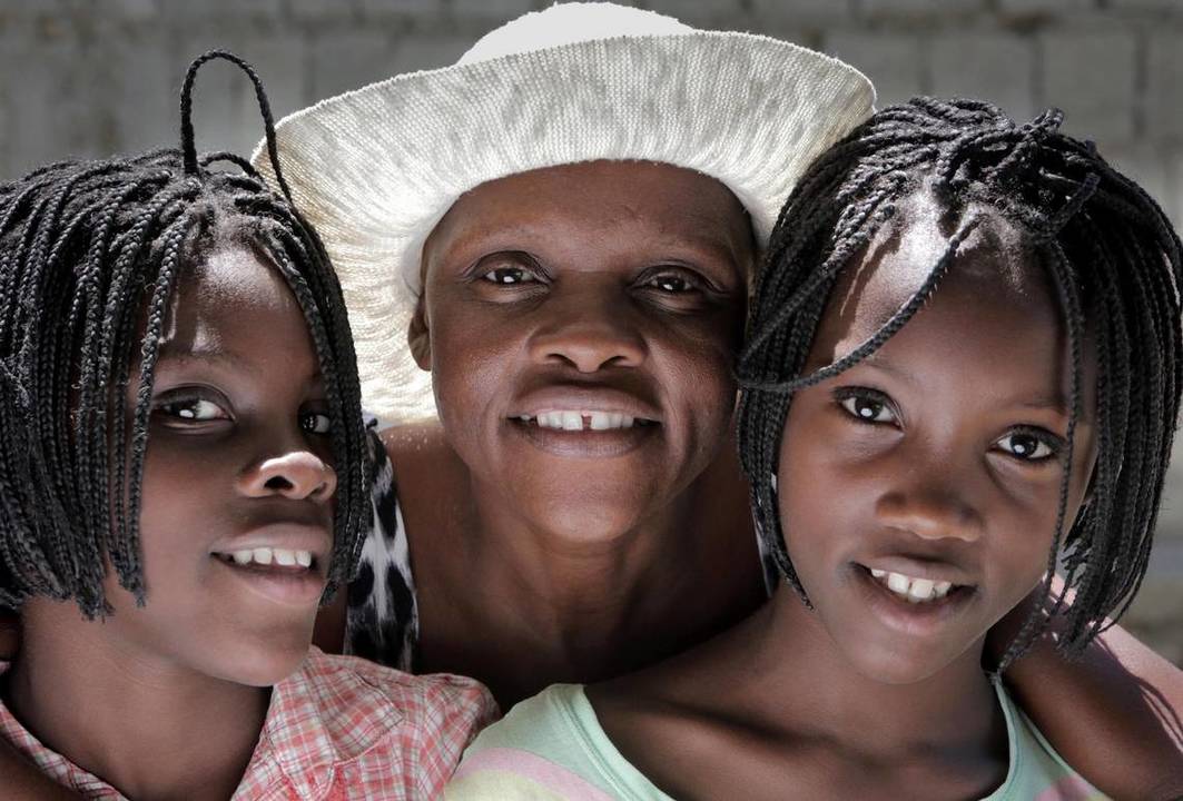 Guerda Janvier (center), who has advanced cervical cancer, wants more than anything to see her 11-year-old twin daughters, Brithney (left) and Briana Osselin (right), grow up.
Image by José A. Iglesias. Haiti, 2018. Guerda Janvier (center), who has advanced cervical cancer, wants more than anything to see her 11-year-old twin daughters, Brithney (left) and Briana Osselin (right), grow up.
Image by José A. Iglesias. Haiti, 2018.