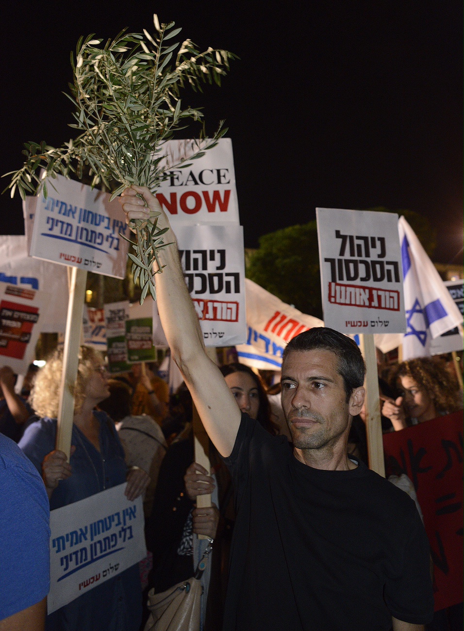 On October 24 in Tel Aviv, peace protesters carry signs and olive branches on the eve of the 20th anniversary (Hebrew calendar) of the assassination of Israeli Prime Minister Yitzhak Rabin. -- Larry Roberts, Pittsburgh Post-Gazette