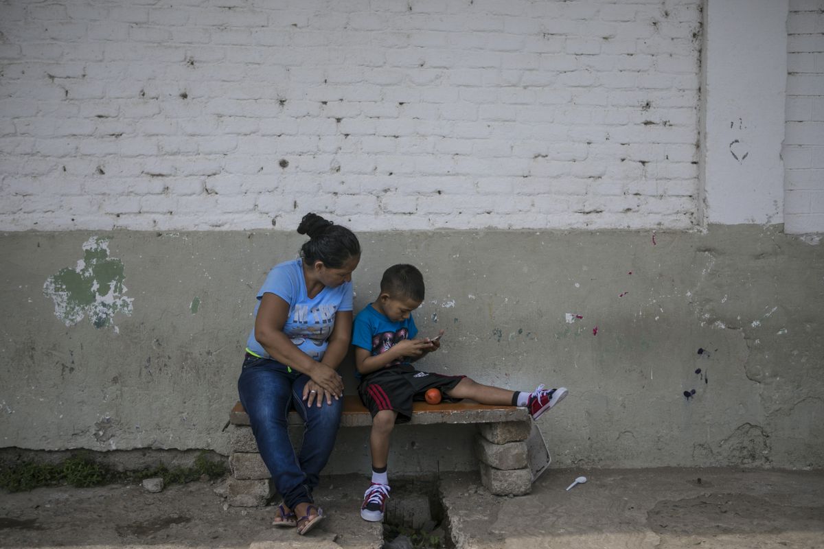 Honduran migrant Sandra and her son, Angel, have been staying at the Todo por Ellos migrant shelter in Tapachula since June. She left behind her husband, a gang member, out of fear that her children would inherit the gang life or be killed. Image by Jose Cabezas. Mexico, 2018. Honduran migrant Sandra and her son, Angel, have been staying at the Todo por Ellos migrant shelter in Tapachula since June. She left behind her husband, a gang member, out of fear that her children would inherit the gang life or be killed. Image by Jose Cabezas. Mexico, 2018.