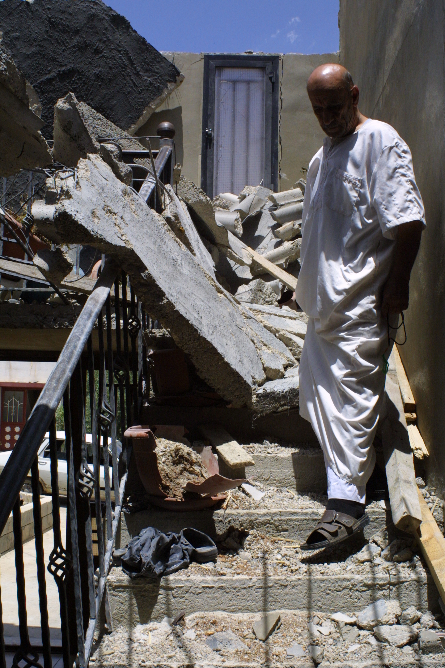 Victim of a Syrian rebel rocket that destroyed his home in Hermel, Lebanon. Pro-Assad forces say rebels target Lebanese civilians, including the Nov. 19 bombing of the neighborhood near the Iran Embassy. Image by Reese Erlich. Syria, 2013. Media file: hermel_victim2.jpg