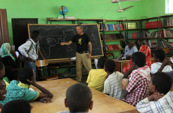 Salopek speaks to students in the Afar region of Ethiopia in February. The Afar are nomads, people who move from place to place, so their schools have to move with them. "The Ethiopian kids would give almost anything to finish their schooling," Salopek said. "They are driven." Image by John Stanmeyer / For National Geographic. Media file: salopek4.png