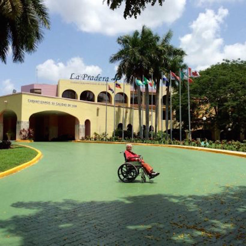 Zuby Malik in front of health facility La Paradera in Havana where she began treatment with the lung cancer vaccine CimaVax this summer. Image by Nauman Malik. Cuba, 2016. Media file: cuba.jpg