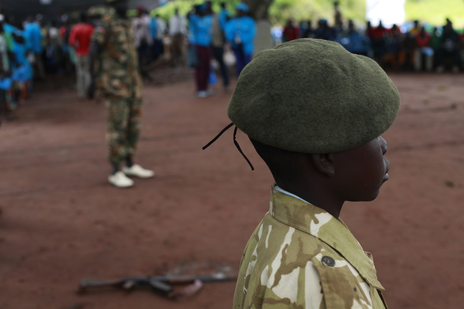 A former child soldier is standing in formation at a child soldiers release ceremony in Yambio, South Sudan. Image by Andreea Campeanu. South Sudan, 2018. A former child soldier is standing in formation at a child soldiers release ceremony in Yambio, South Sudan. Image by Andreea Campeanu. South Sudan, 2018.