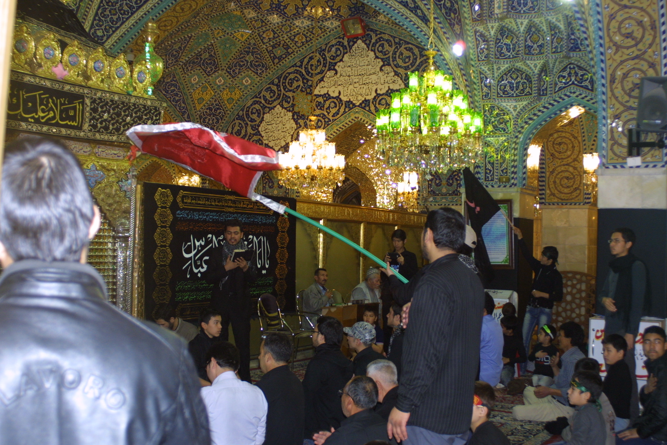 Men and boys pray at the Rukaya Shrine, Damascus. Image by Reese Erlich. Syria, 2013.